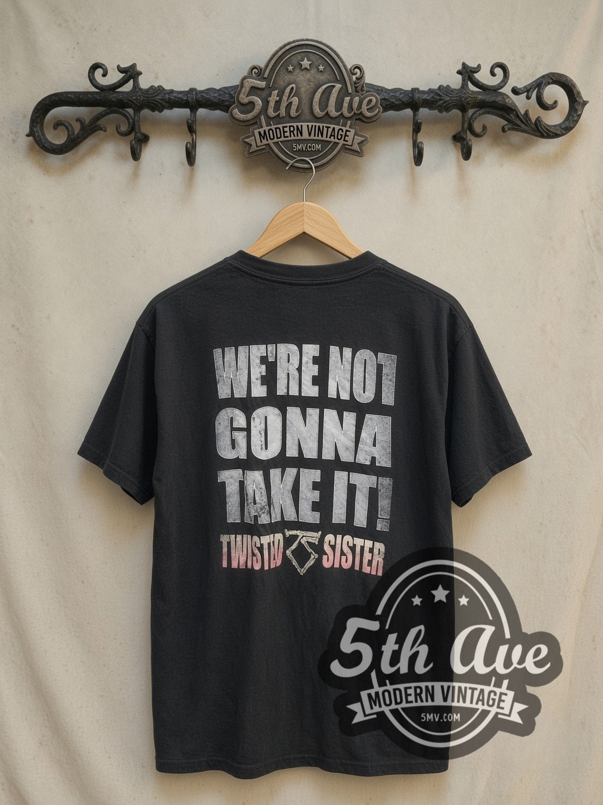 Twisted Sister Bone TS Logo Pink Band Name vintage band t-shirt, back view on a display rack