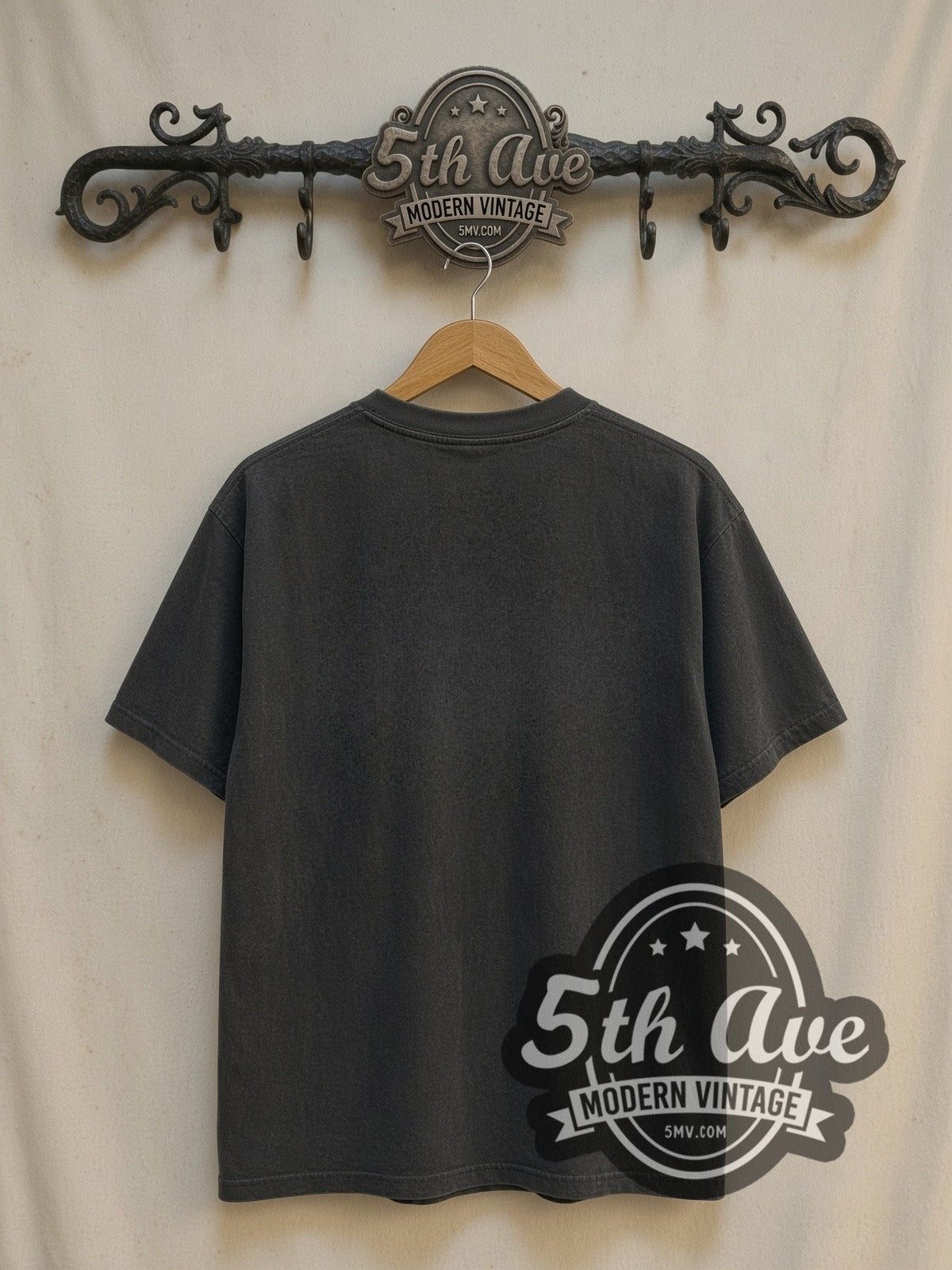 Eminem × Stüssy Pins and Needles vintage band t-shirt, back view on a display rack