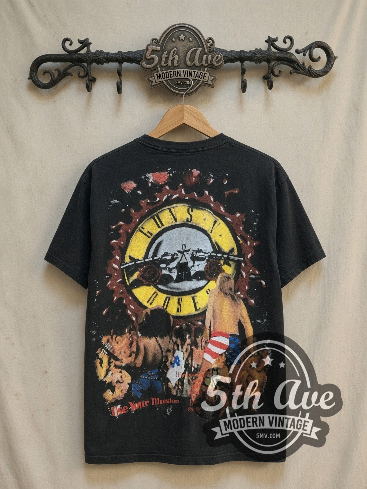 Guns N' Roses Axl Rose American Flag Splatter Logo vintage band t-shirt, back view on a display rack