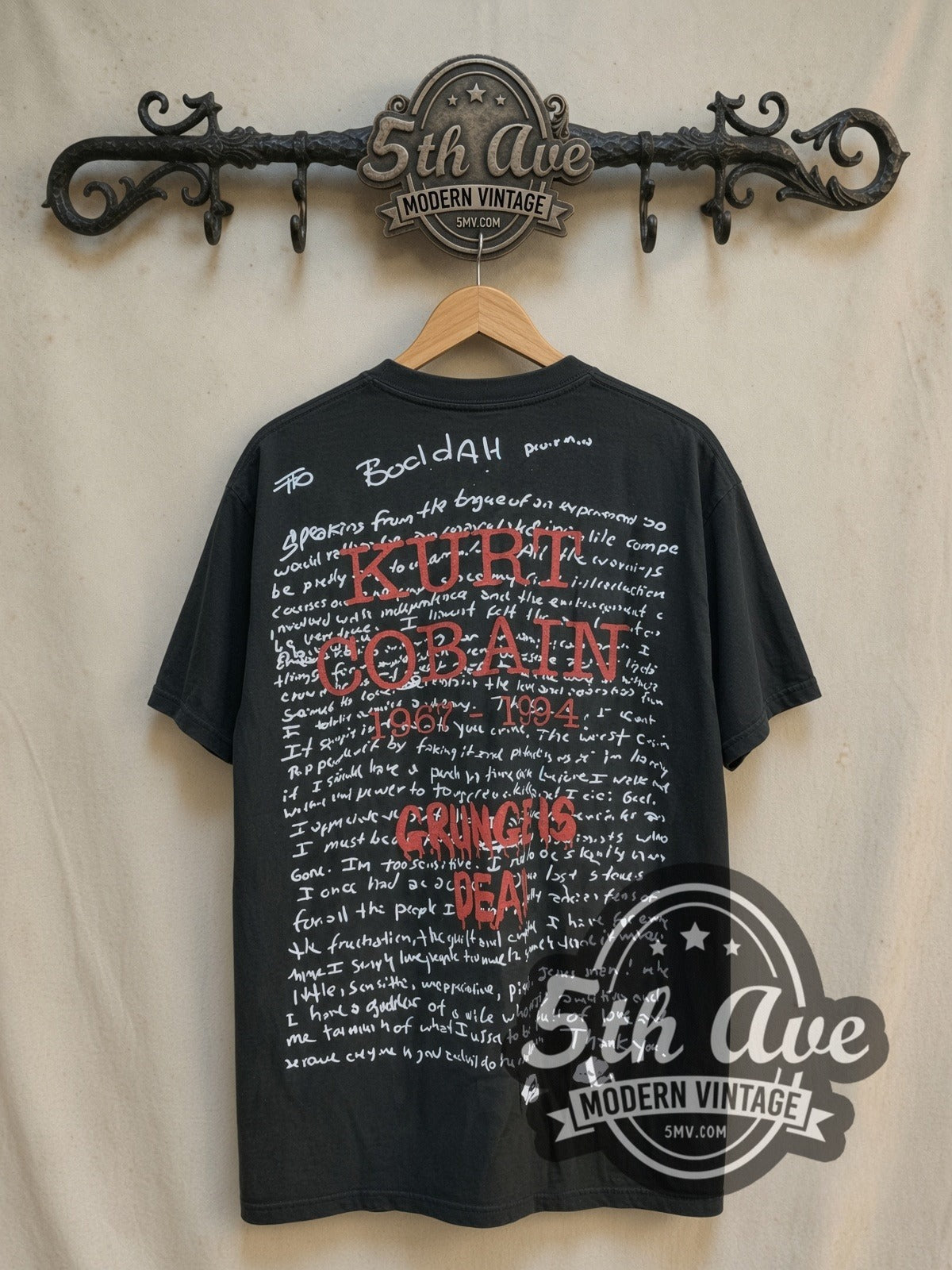 Nirvana Nevermind Grunge Is Dead all-over-print vintage band t-shirt, back view on a display rack