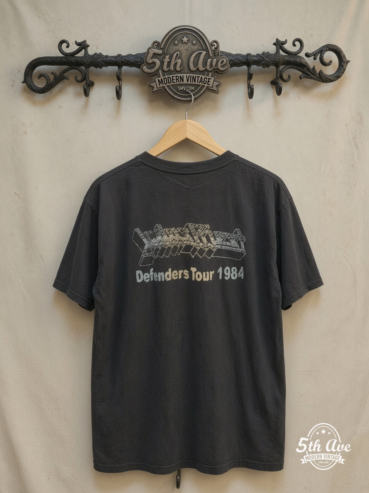 Judas Priest – Defenders Tour 1984 – Vintage Band T-Shirt — back on locked cream ornate 5th Ave rack