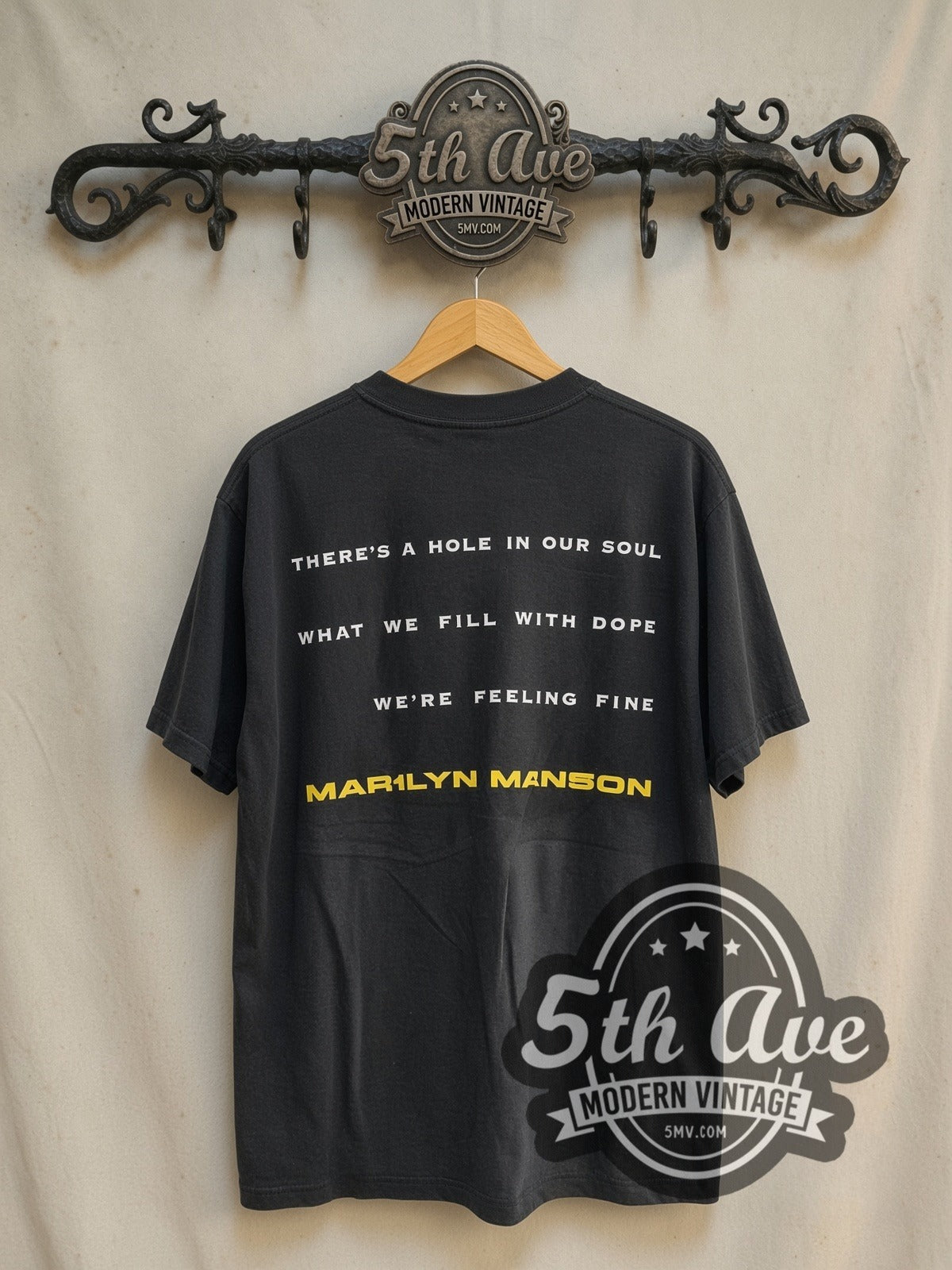 Marilyn Manson 'I Don't Like the Drugs' (But the Drugs Like Me) vintage band t-shirt in black, back view on a display rack