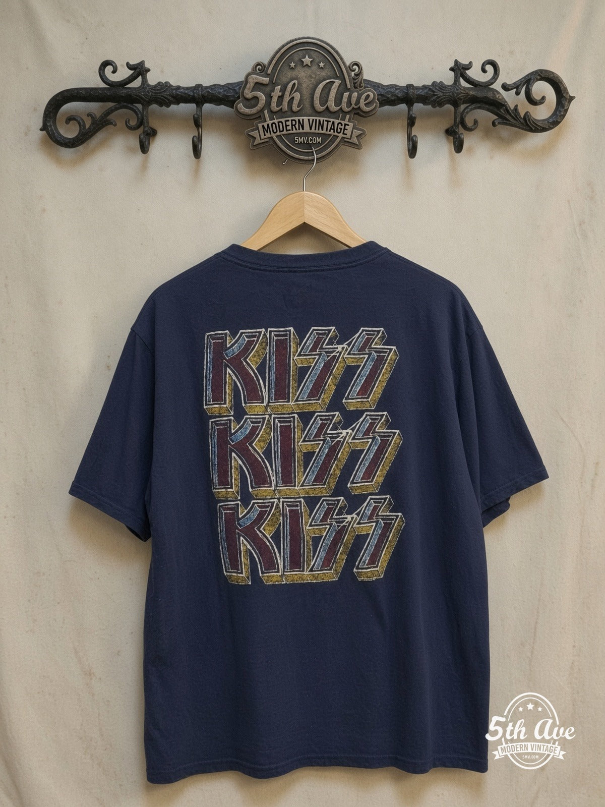 KISS – Triple Logo – Vintage Band T-Shirt — back on locked cream ornate 5th Ave rack