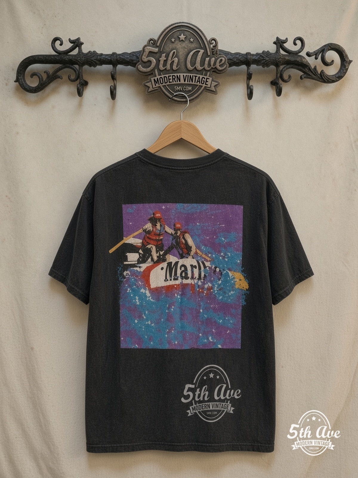 Marlboro Adventure Team graphic tee in black, back view on a display rack
