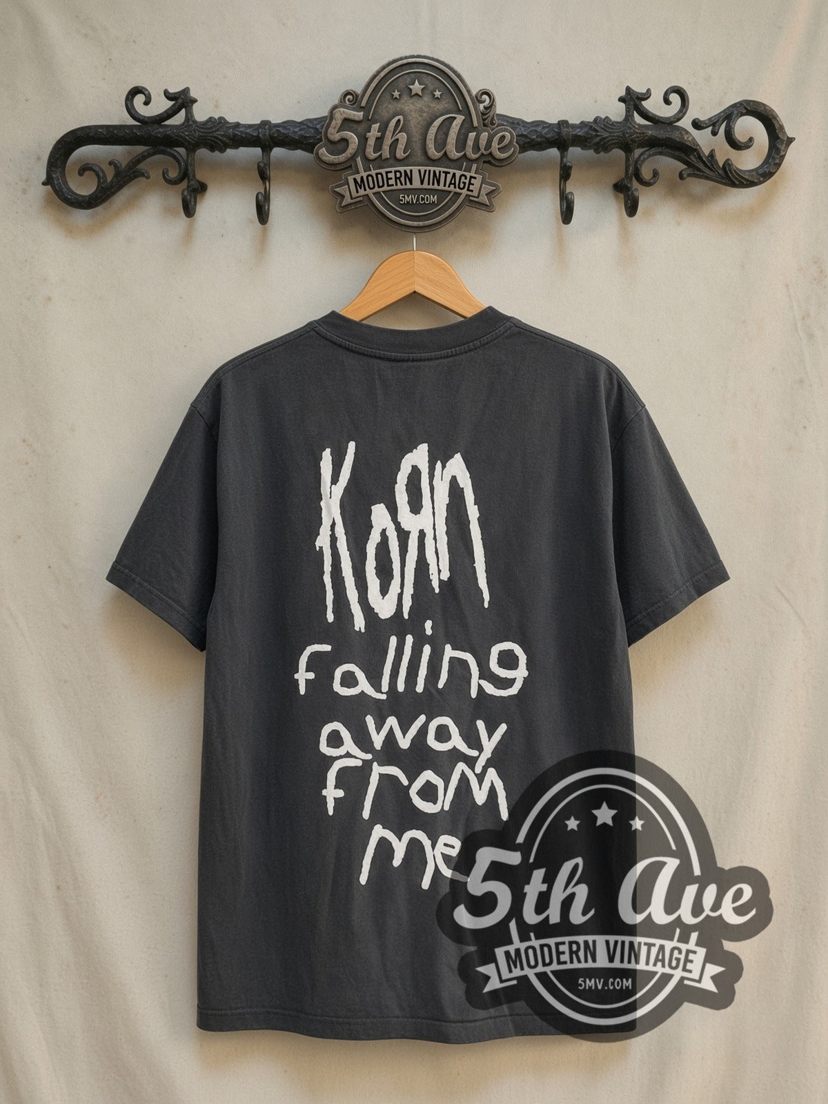 Korn Falling Away from Me vintage band t-shirt in black, back view on a display rack