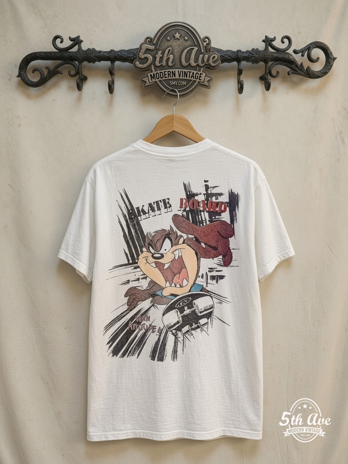 Looney Tunes – Taz-Mania Skateboard – New Vintage Graphic Tee — back on locked cream ornate 5th Ave rack