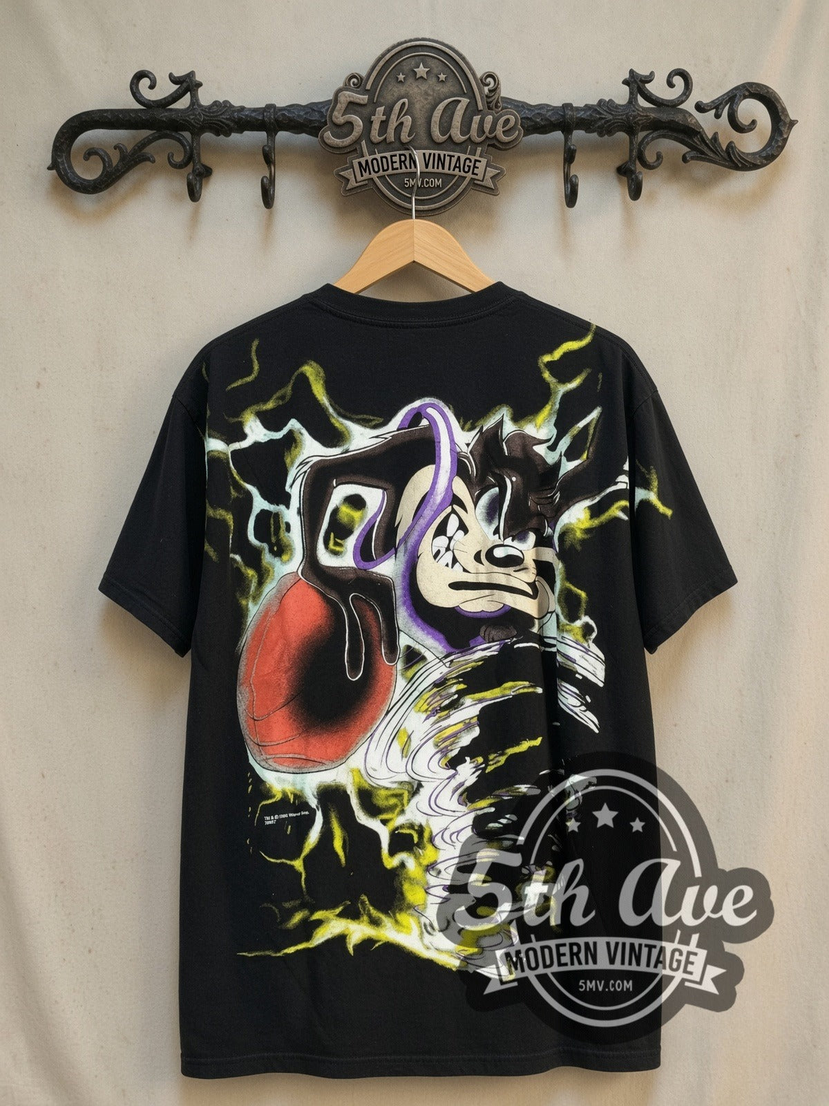 Looney Tunes Taz-Mania Taz Tunes all-over-print vintage cartoon tee, back view on a display rack