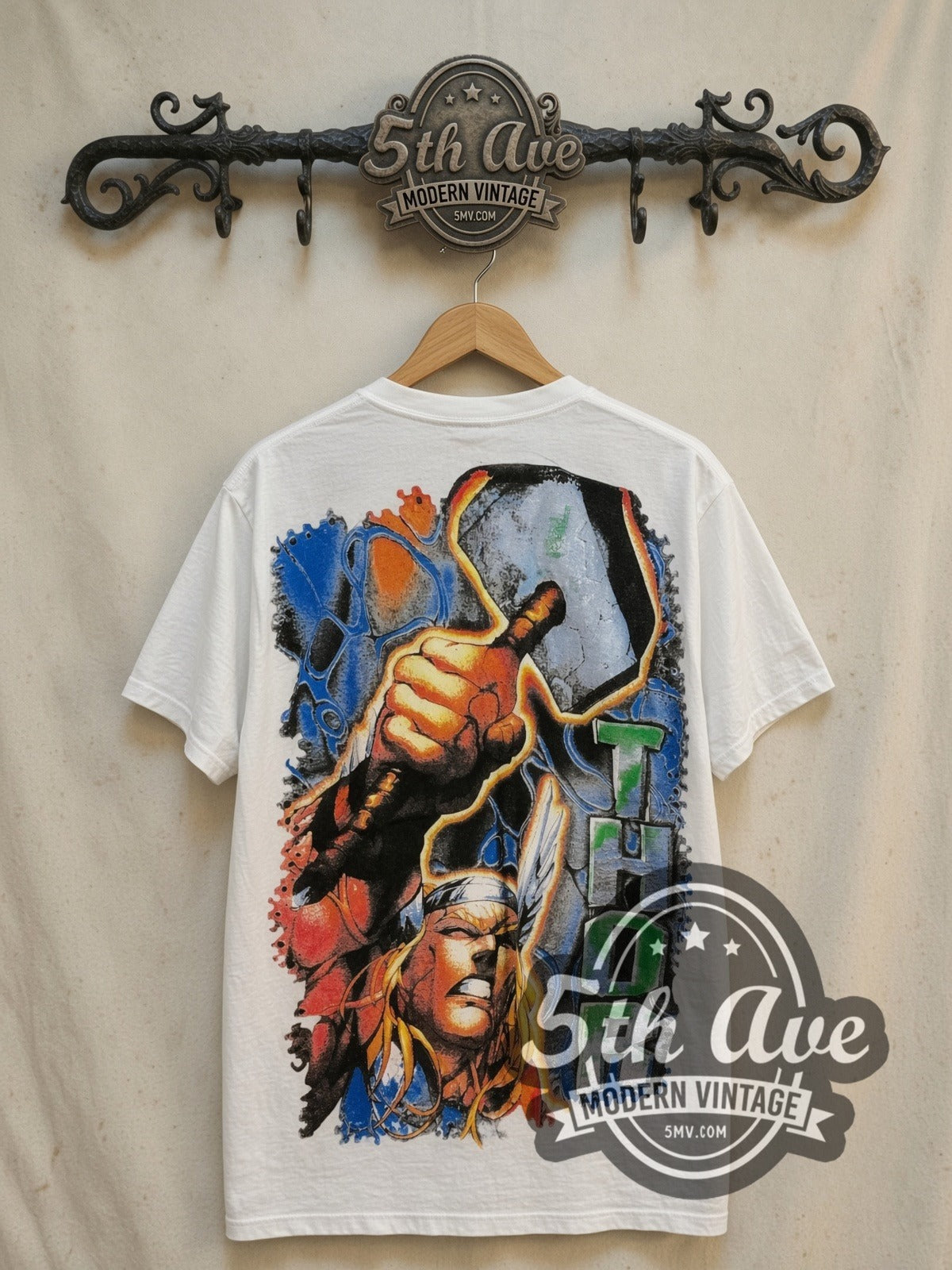 Marvel Thor Odinson Mjolnir Comic all-over-print vintage comic tee in white, back view on a display rack