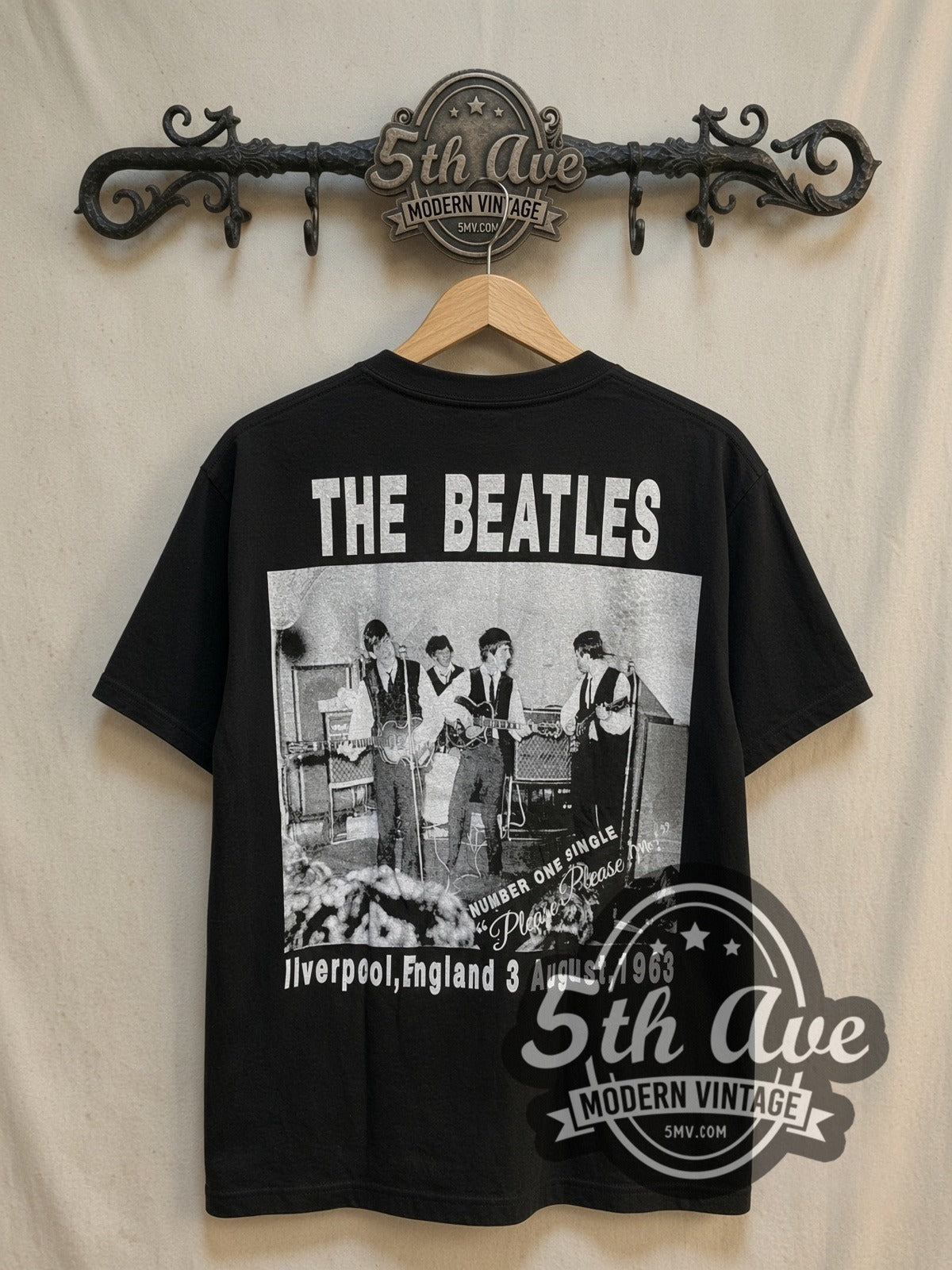 The Beatles Yellow Border Early Suits Photo vintage band t-shirt, back view on a display rack