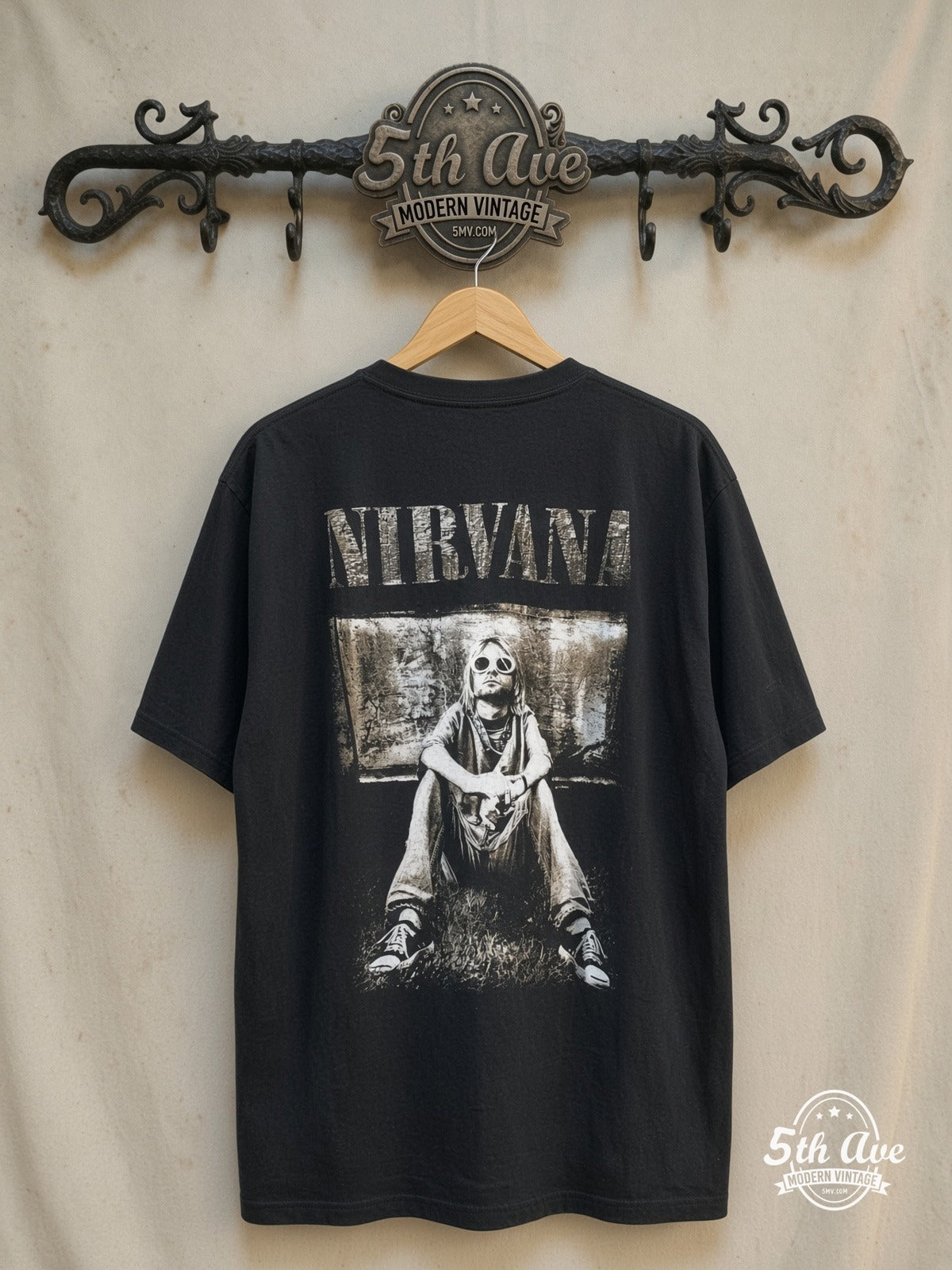 Kurt Cobain – Nirvana Retro Portrait – Vintage Band T-Shirt — back on locked cream ornate 5th Ave rack