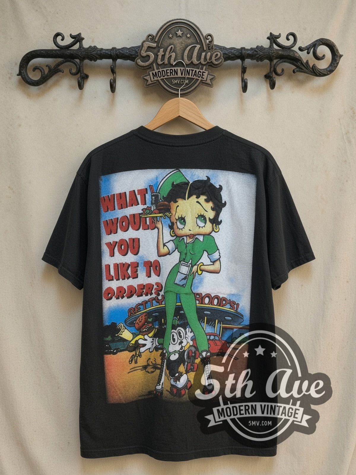 Betty Boop What Would You Like to Order all-over-print vintage cartoon tee, back view on a display rack