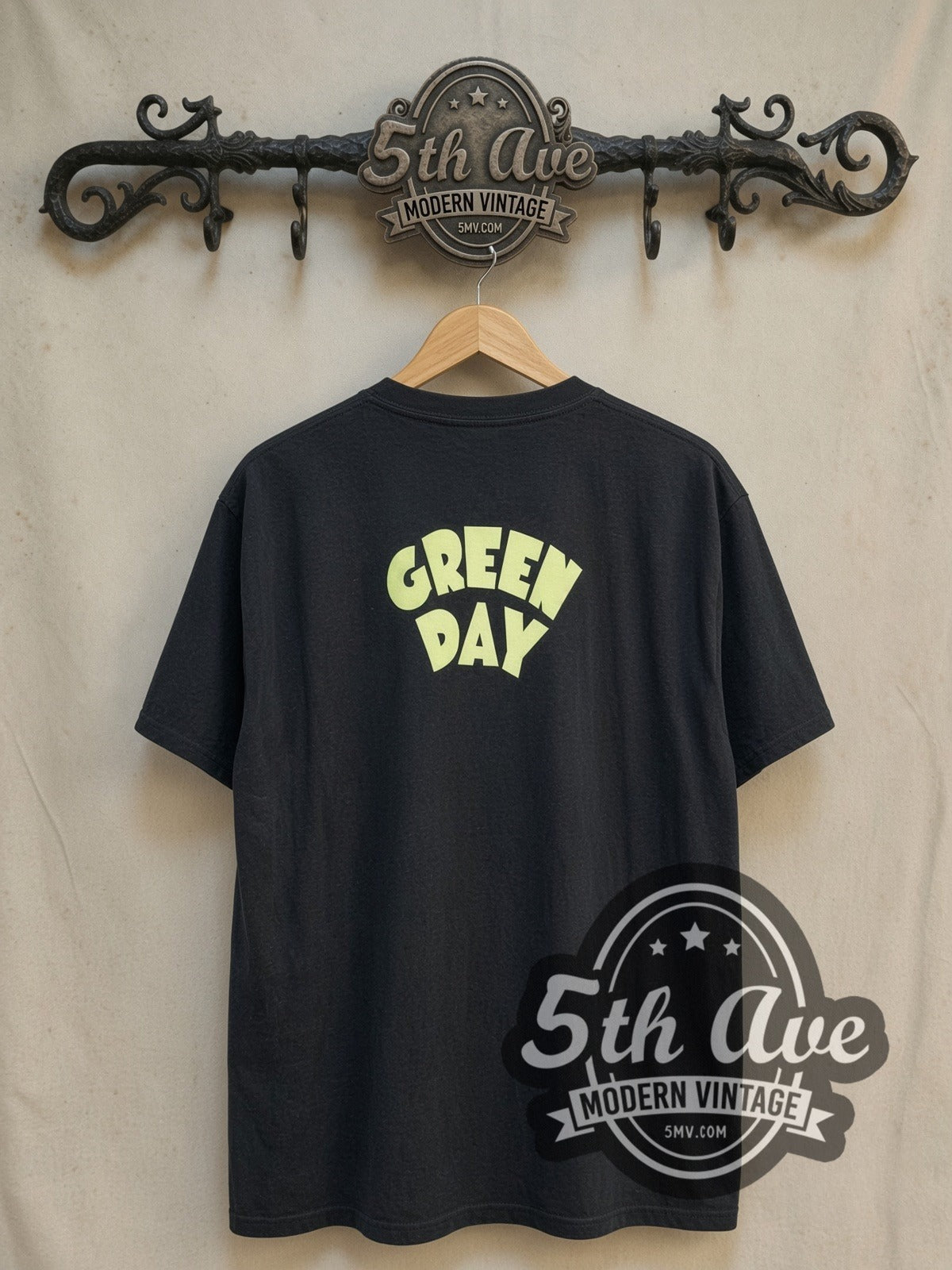 Green Day Dookie Album Cover Bomber vintage band t-shirt, back view on a display rack