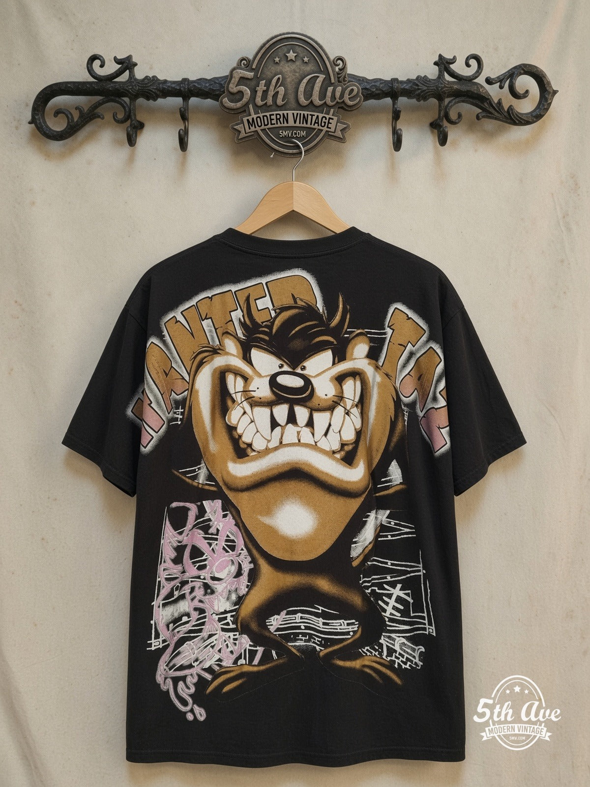 Looney Tunes – Taz-Mania Who Let The Taz Out? - AOP all over print New Vintage Animat – New Vintage Graphic Tee — back on locked cream ornate 5th Ave rack