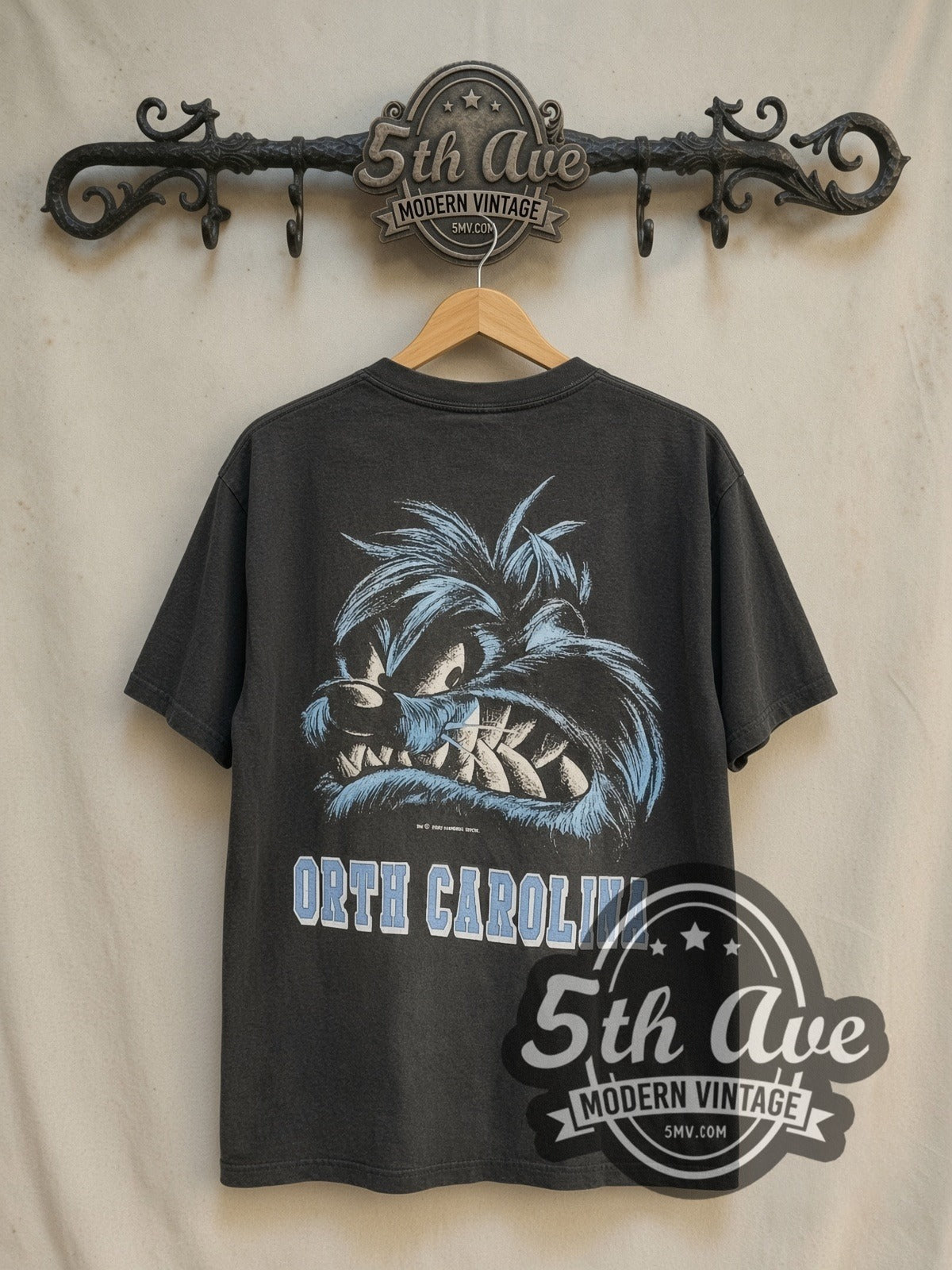 Looney Tunes Taz-Mania North Carolina vintage cartoon tee in black, back view on a display rack