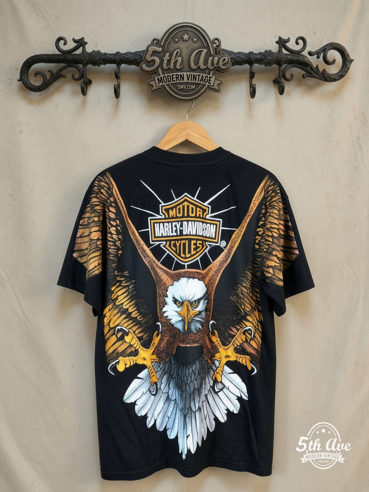 Harley-Davidson all-over-print graphic tee, back view on a display rack