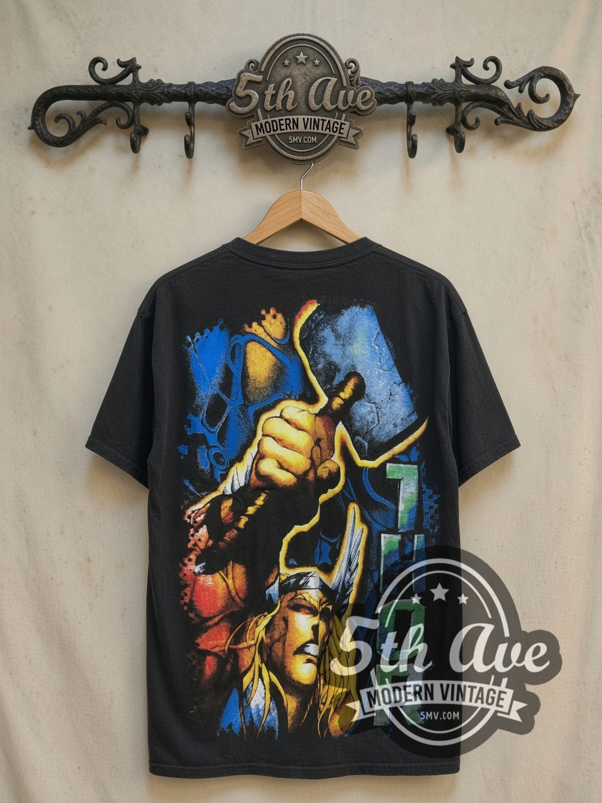 Marvel Thor Odinson Mjolnir Comic all-over-print vintage comic tee in black, back view on a display rack