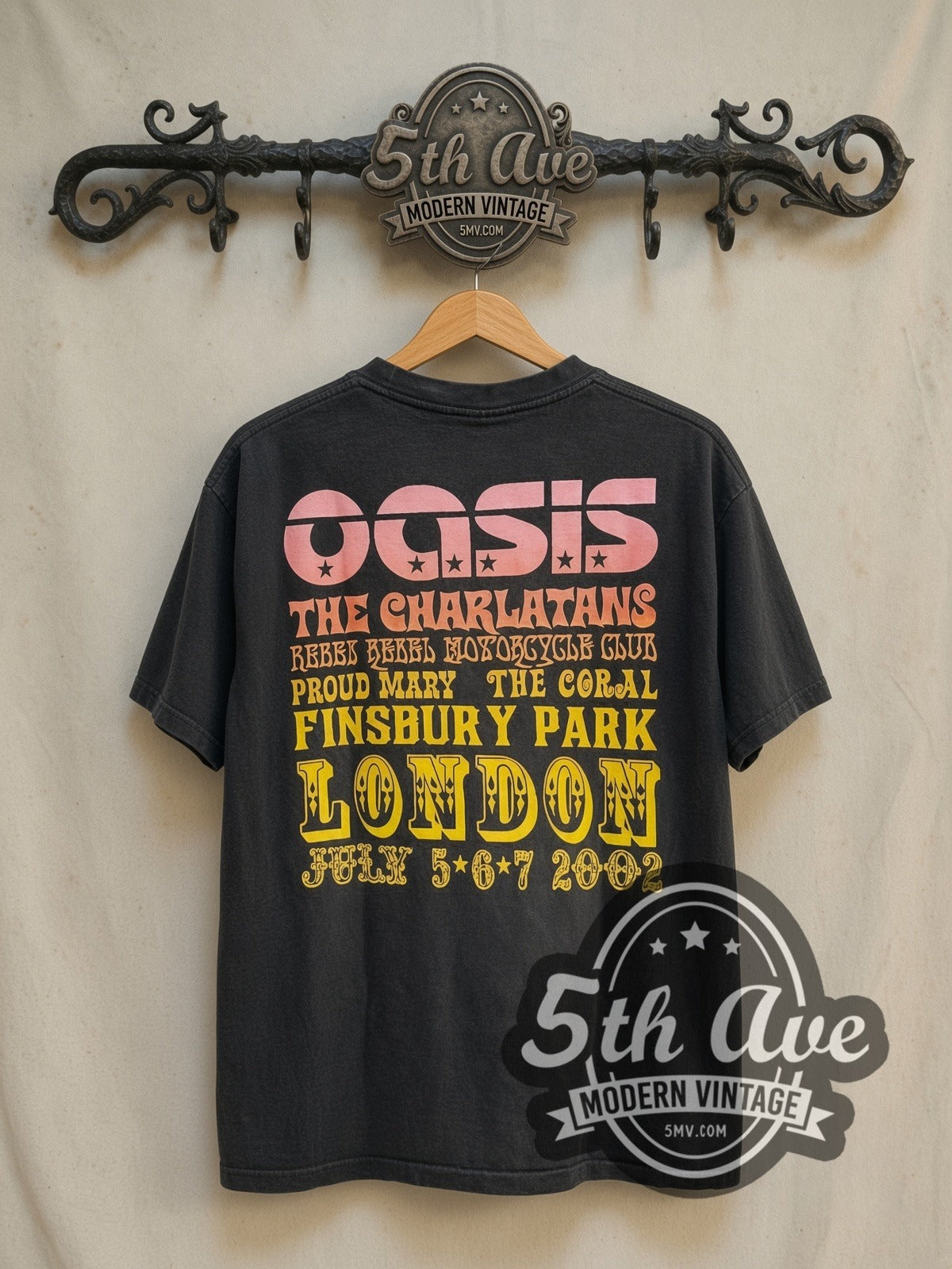 Oasis The Charlatans, Black Rebel Motorcycle Club, Proud Mary and vintage band t-shirt in black, back view on a display rack