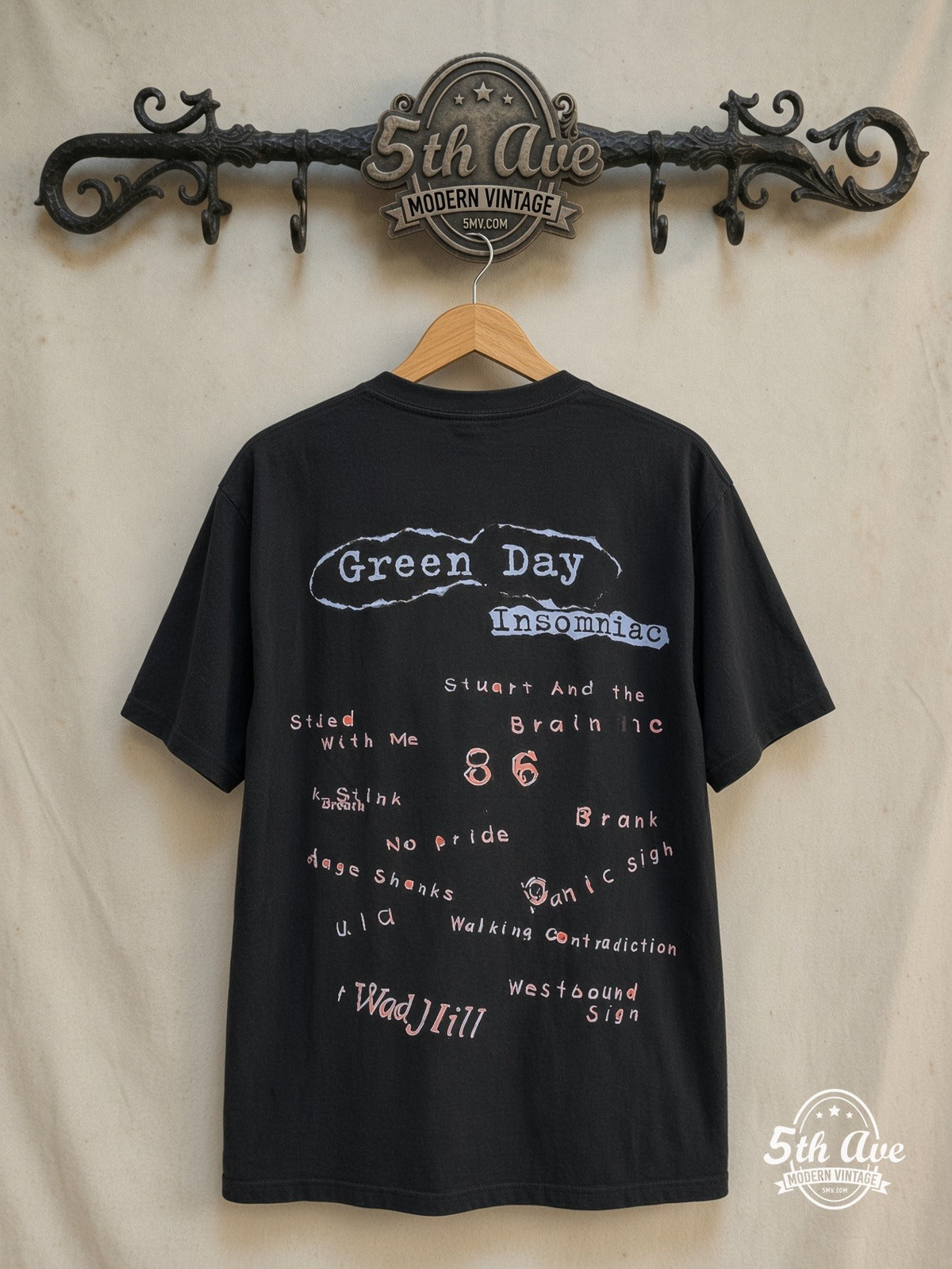 Green Day – Insomniac – All Over Print – Vintage Band T-Shirt — back on locked cream ornate 5th Ave rack