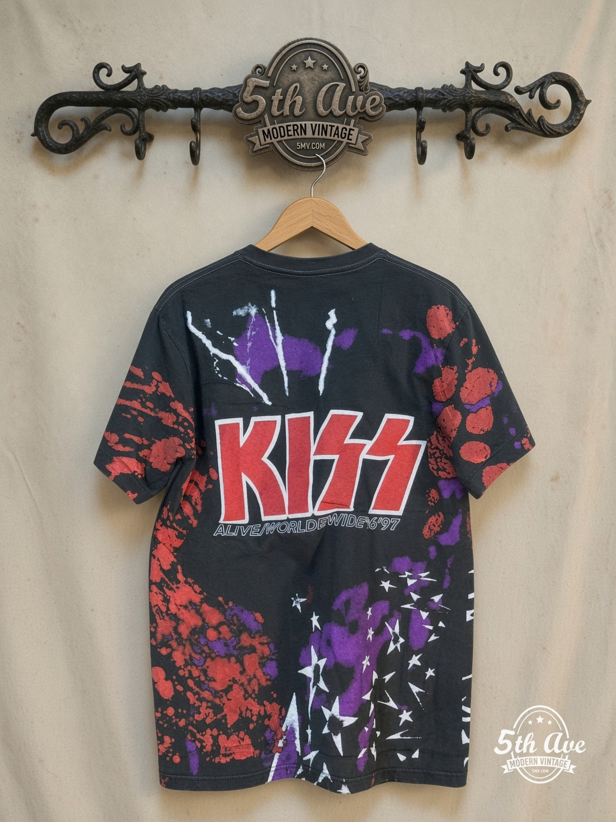 KISS Alive/Worldwide Tour all-over-print vintage band t-shirt, back view on a display rack