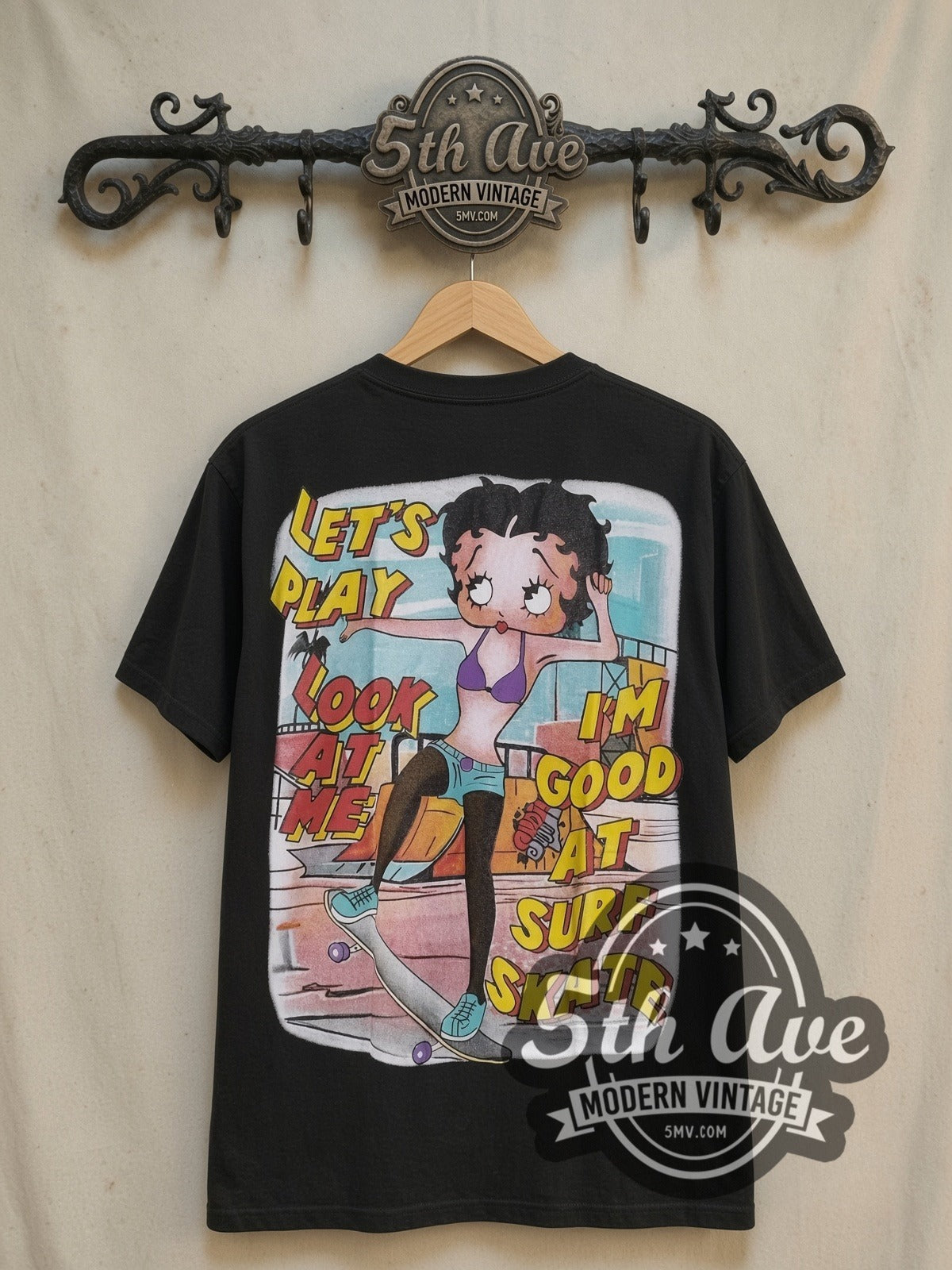 Betty Boop I'm Good at Surf Skate vintage cartoon tee, back view on a display rack