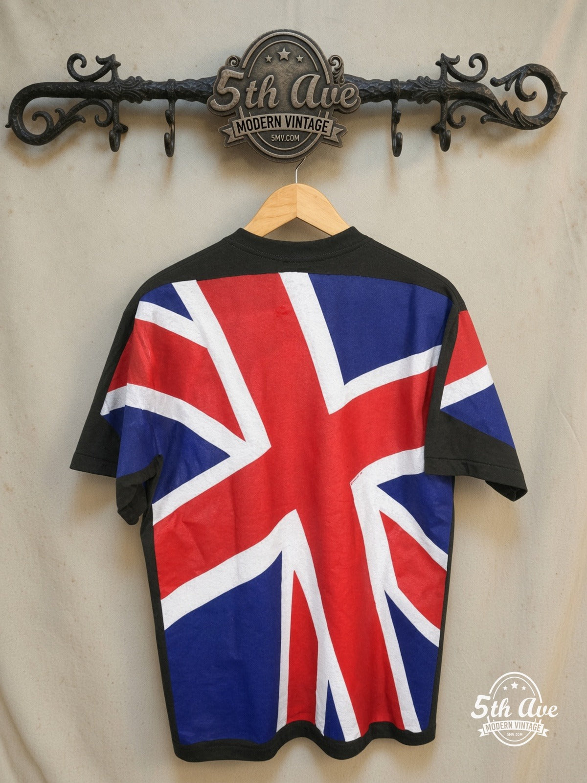 UK Union Jack – Union Flag All-Over Print – Vintage Graphic Tee — back on locked cream ornate 5th Ave rack
