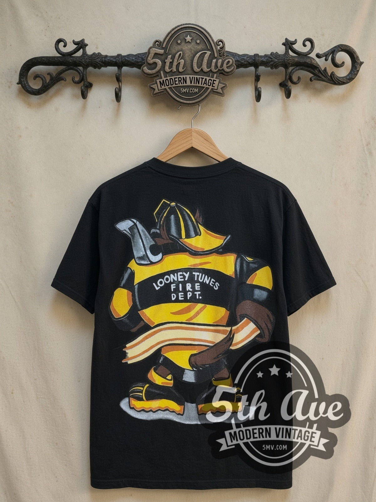 Looney Tunes Taz-Mania Fire Department all-over-print vintage cartoon tee, back view on a display rack