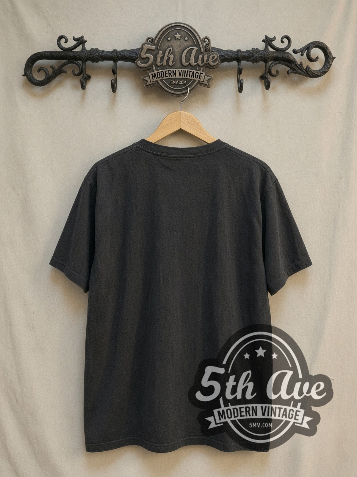 The Cure Five Member Photo Blue Logo vintage band t-shirt, back view on a display rack