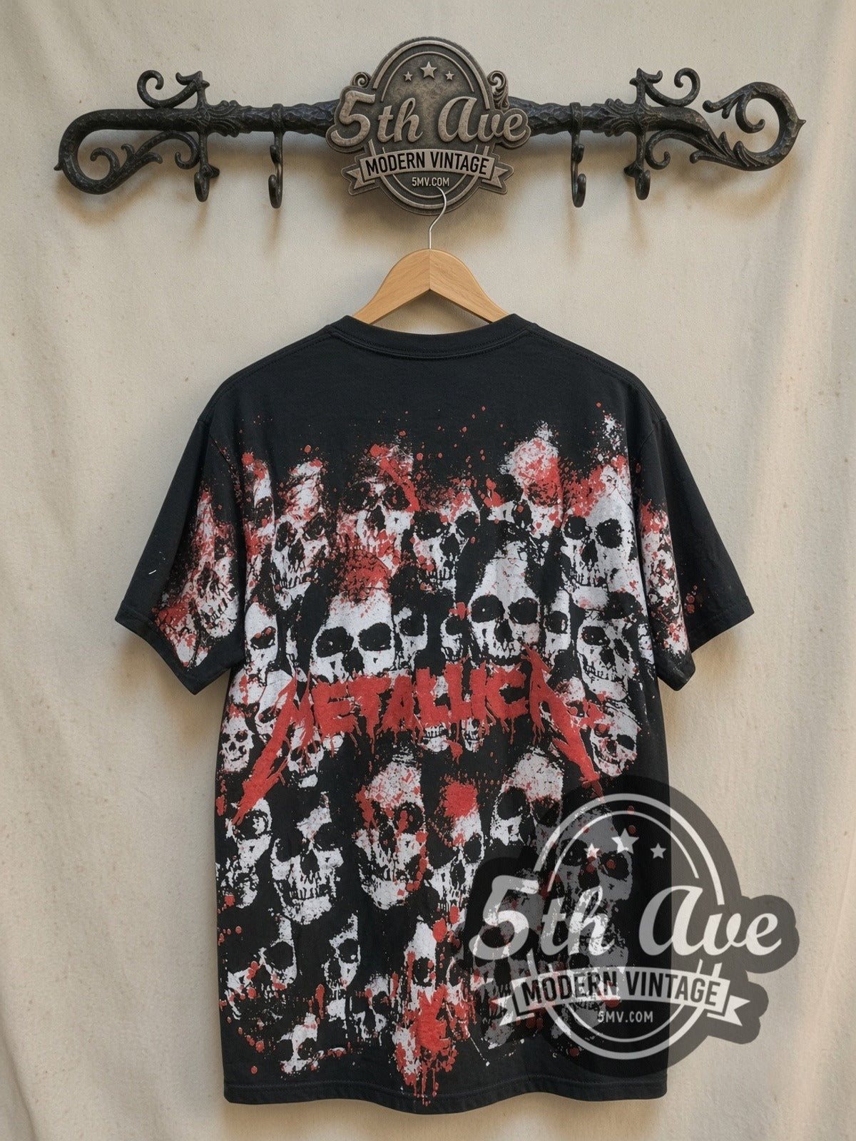 Metallica Unleash the Metal all-over-print vintage band t-shirt, back view on a display rack