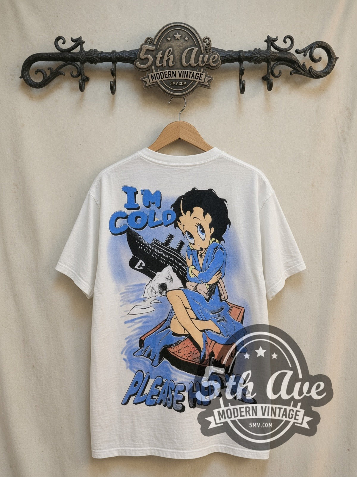 Betty Boop, Popeye and Titanic all-over-print vintage cartoon tee, back view on a display rack