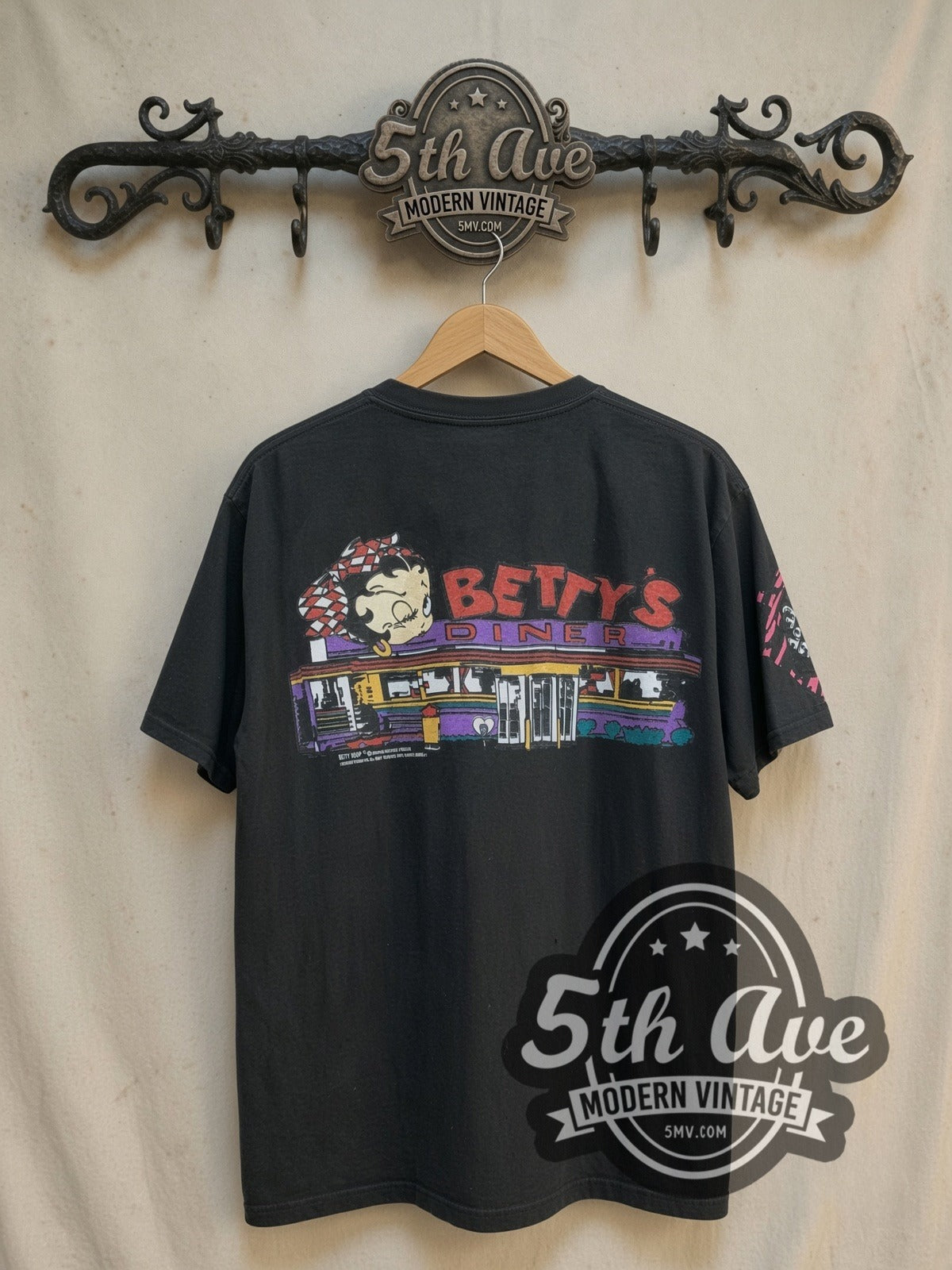 Betty Boop's Diner Served Hot and Fresh all-over-print vintage cartoon tee, back view on a display rack