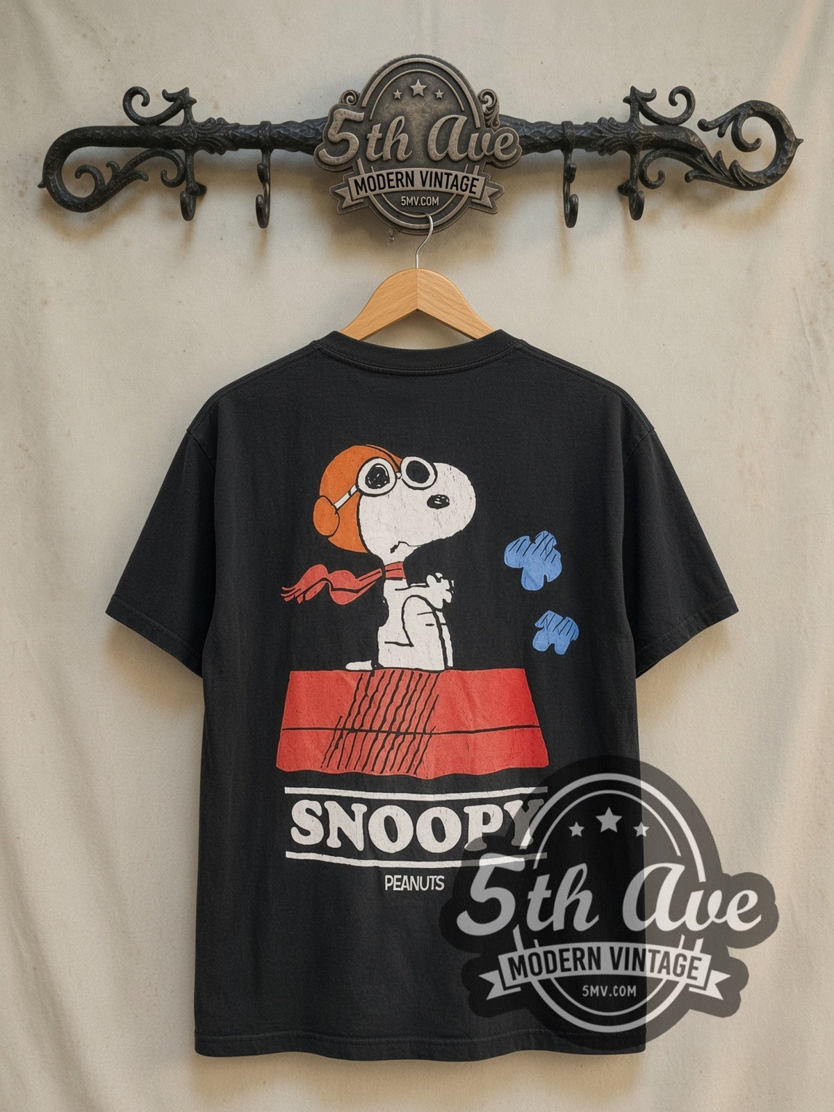 Peanuts Snoopy Trust Me I'm a Pilot vintage cartoon tee in black, back view on a display rack