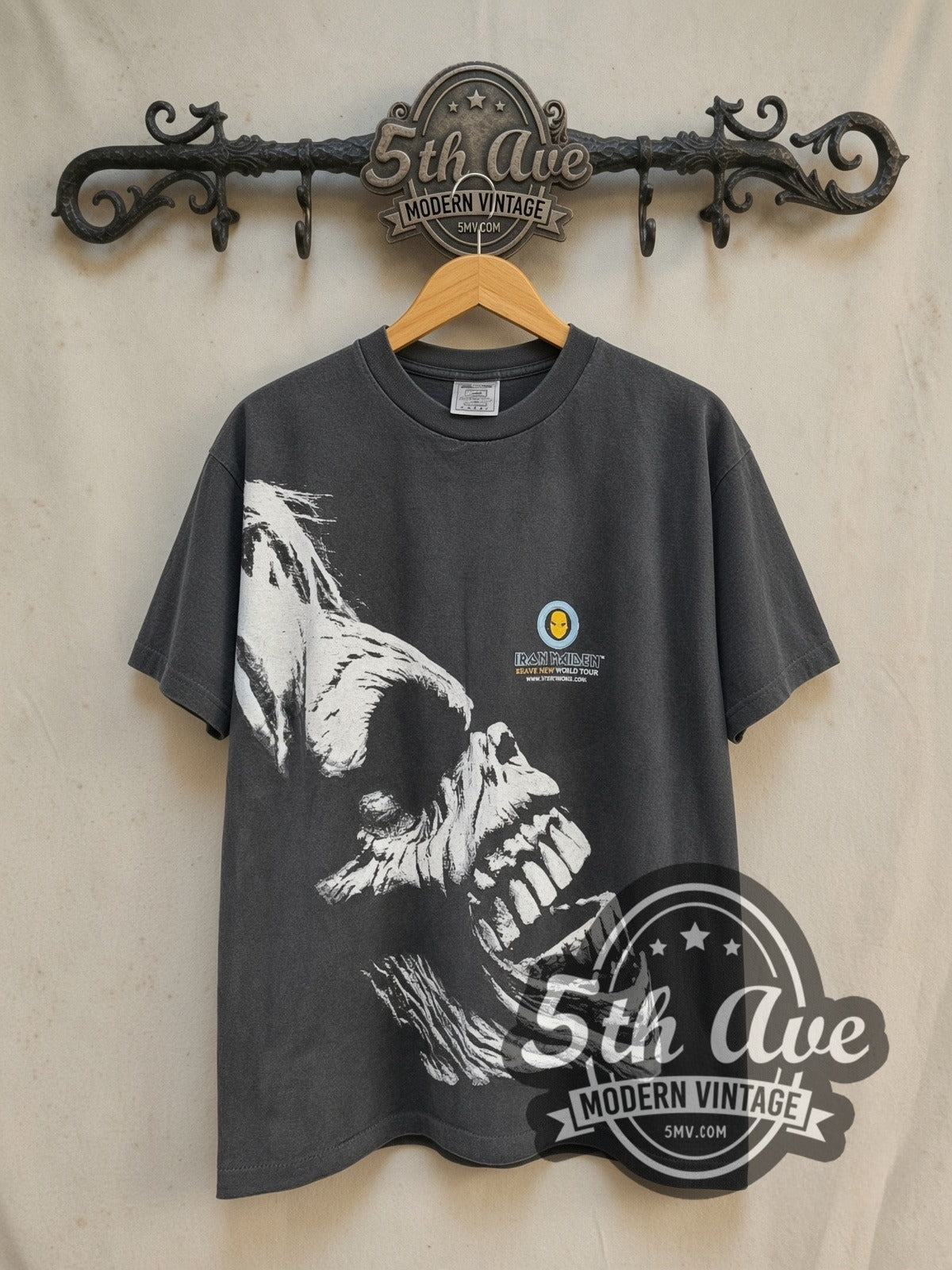 Iron Maiden Brave New World Tour all-over-print vintage band t-shirt in black, front view on a display rack