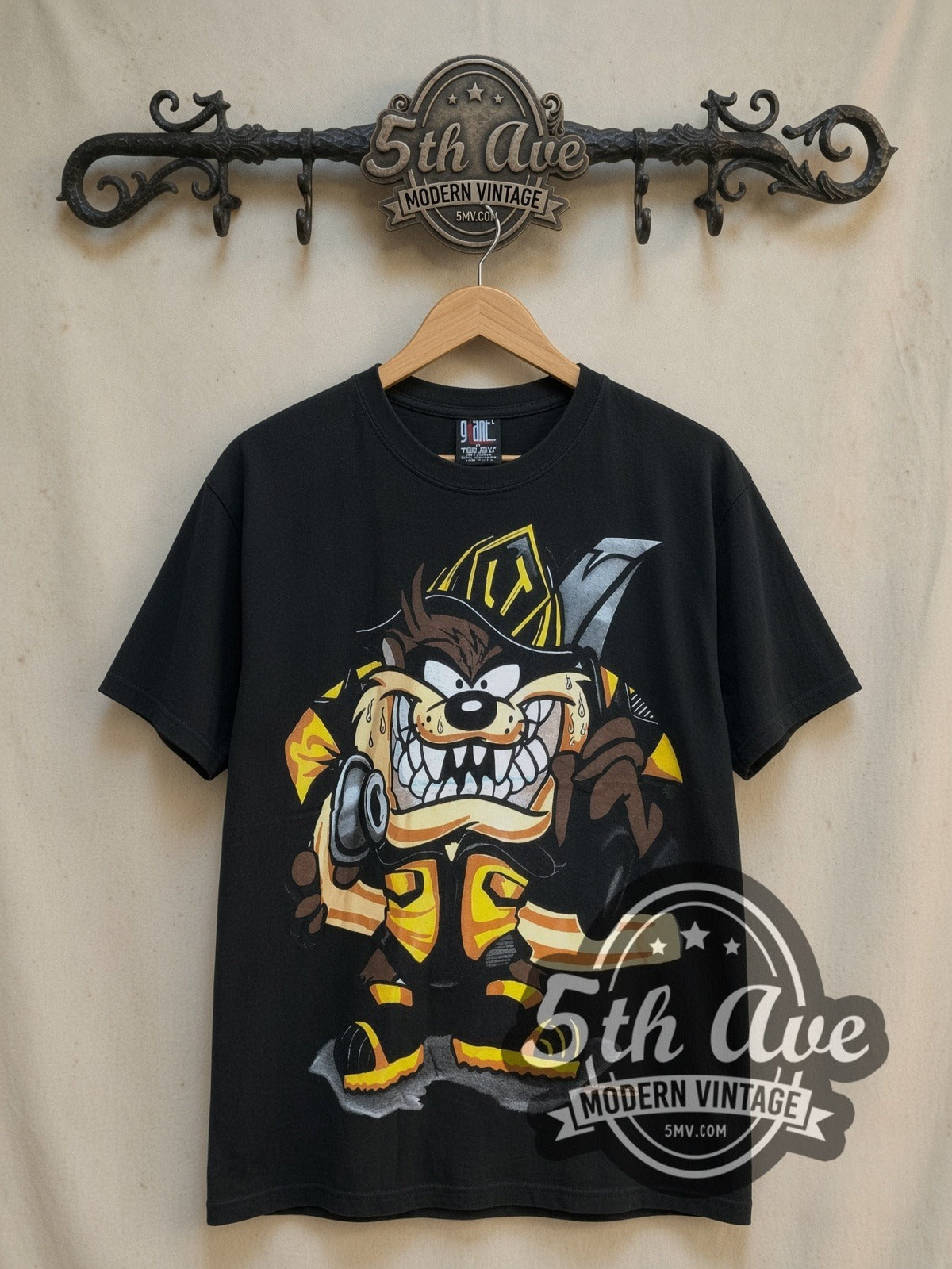 Looney Tunes Taz-Mania Fire Department all-over-print vintage cartoon tee, front view on a display rack
