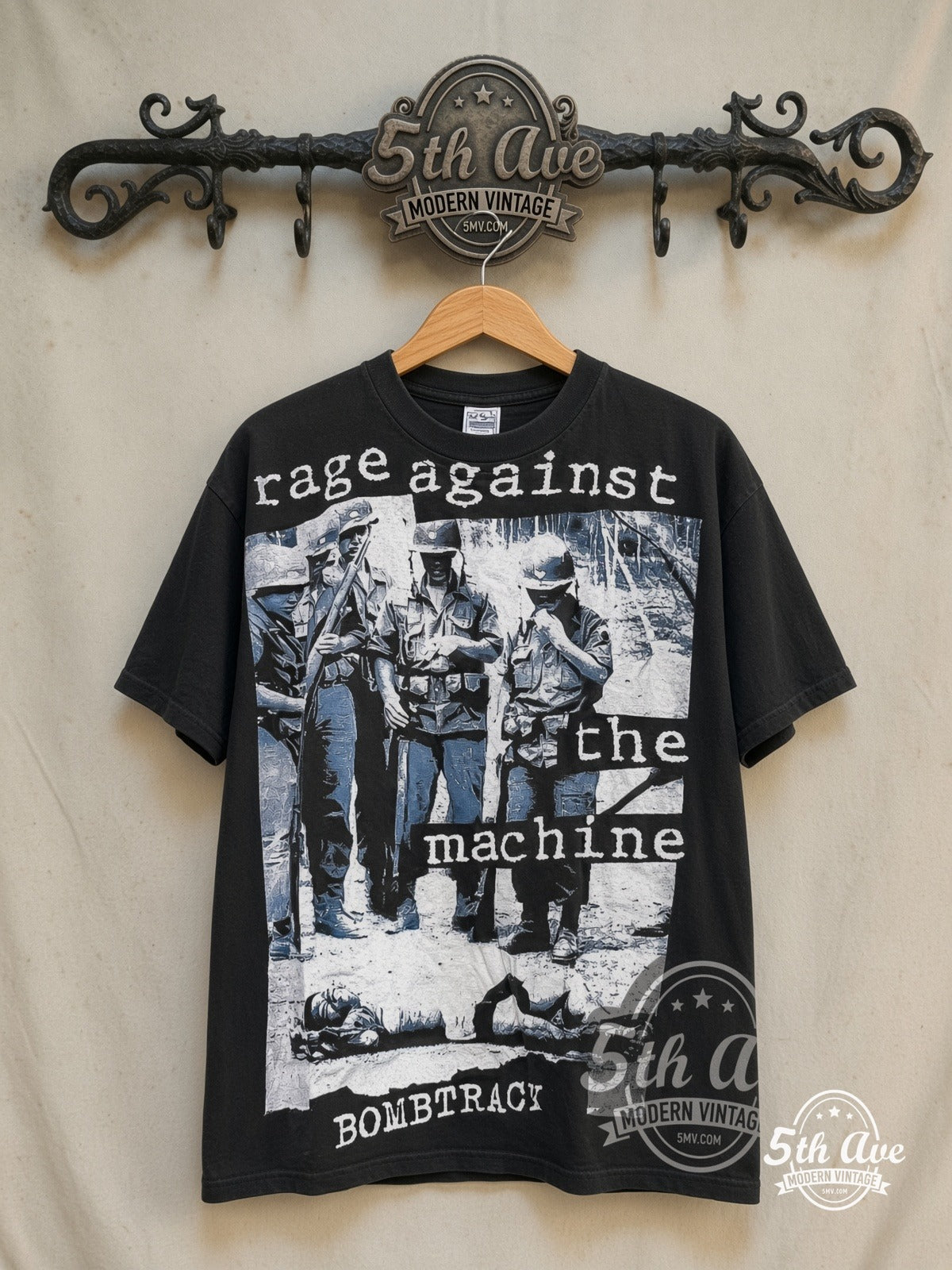 Rage Against the Machine – Bombtrack Blue Soldier – All Over Print – Vintage Band T-Shirt — front on locked cream ornate 5th Ave rack