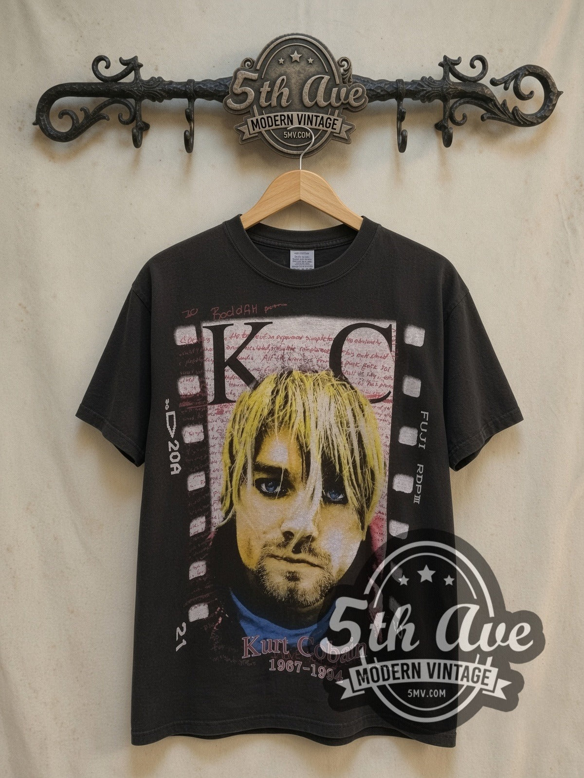 Nirvana Kurt Cobain KC Film Strip 1967-1994 vintage band t-shirt, front view on a display rack