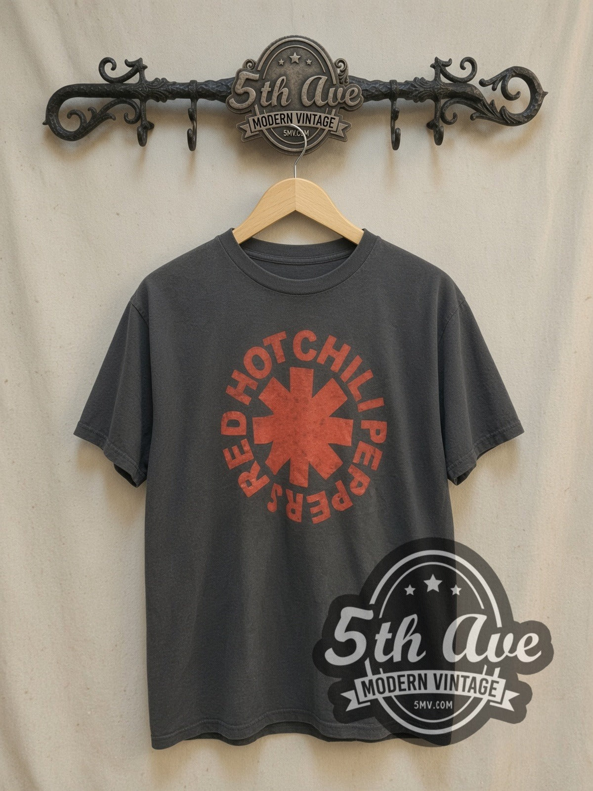 Red Hot Chili Peppers Classic Red Asterisk Circle Logo vintage band t-shirt, front view on a display rack