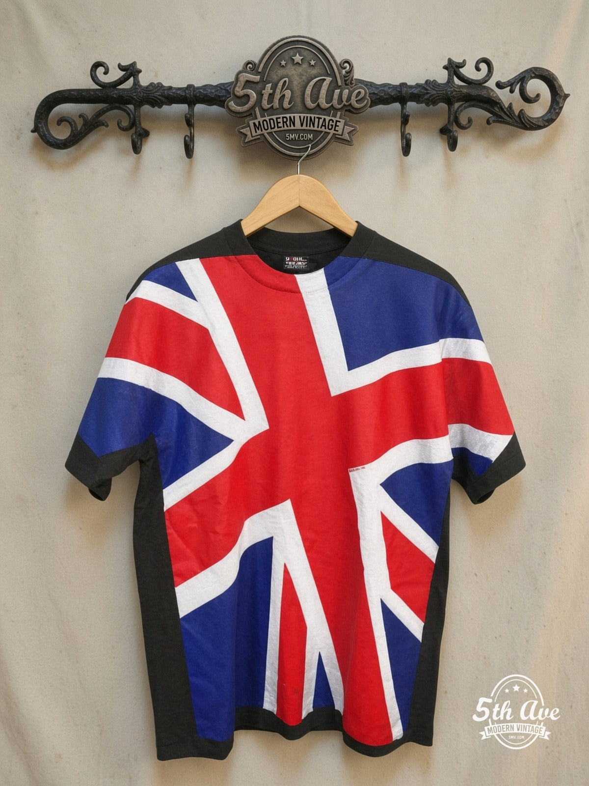 UK Union Jack – Union Flag All-Over Print – Vintage Graphic Tee — front on locked cream ornate 5th Ave rack