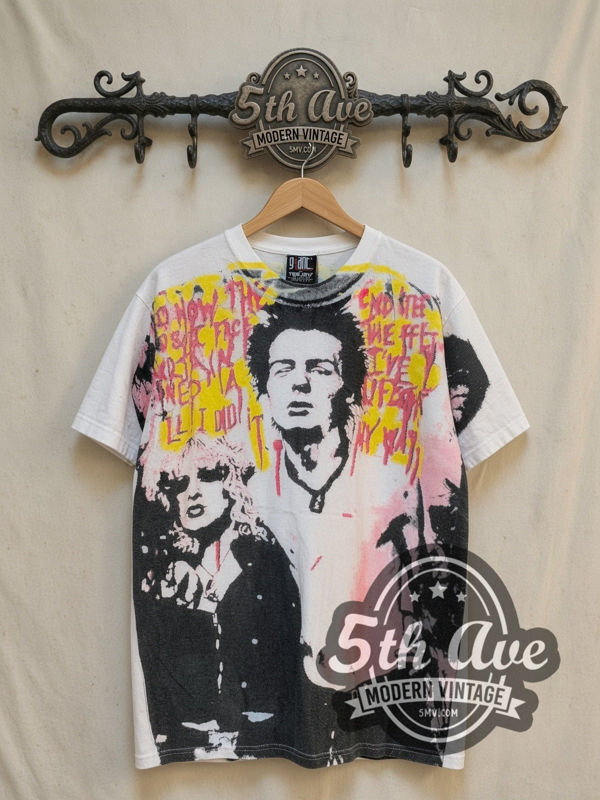 Sex Pistols Sid Vicious and Nancy all-over-print vintage band t-shirt, front view on a display rack