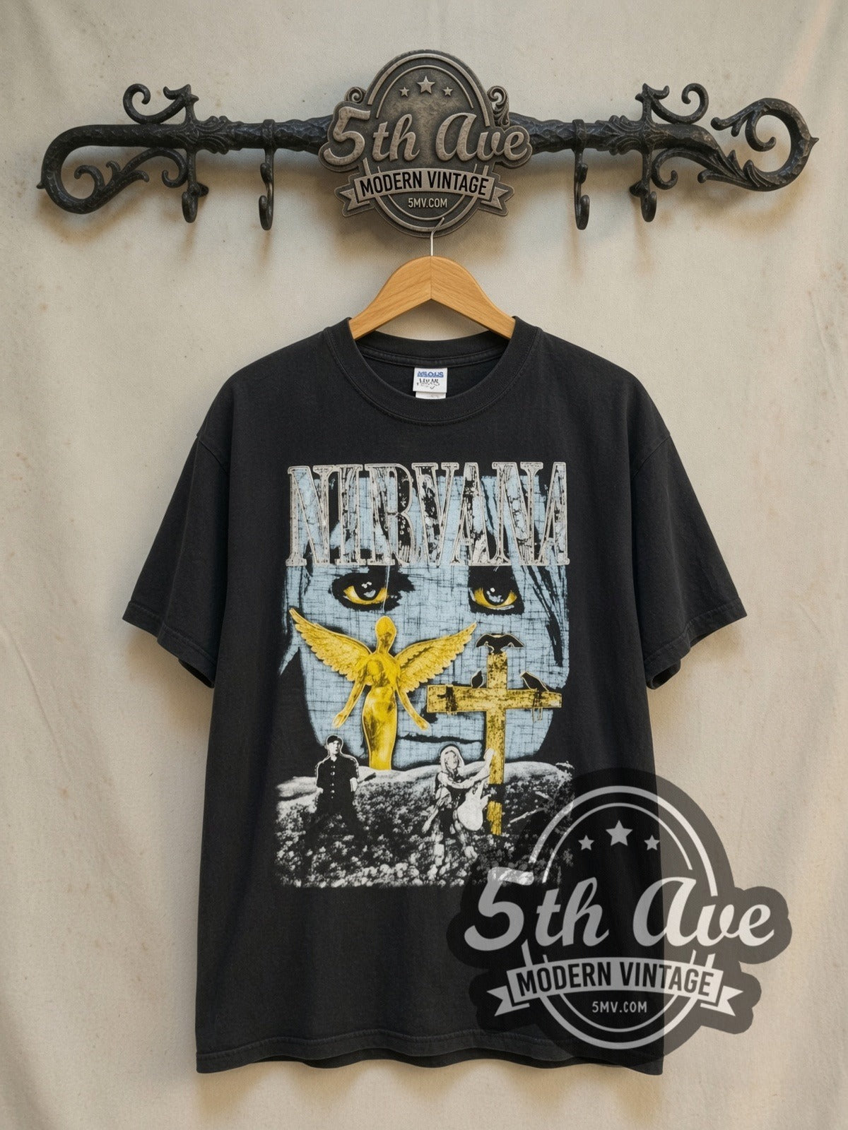 Nirvana In Utero Gold Cross vintage band t-shirt in black, front view on a display rack
