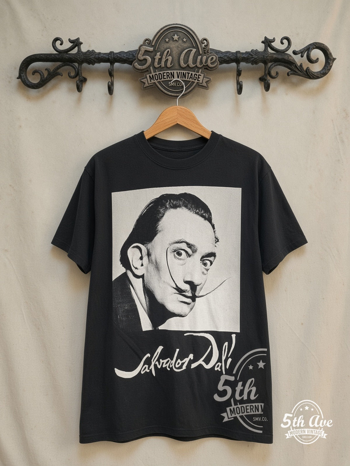 Salvador Dalí – Avida Dollars – Vintage Graphic Tee — front on locked cream ornate 5th Ave rack