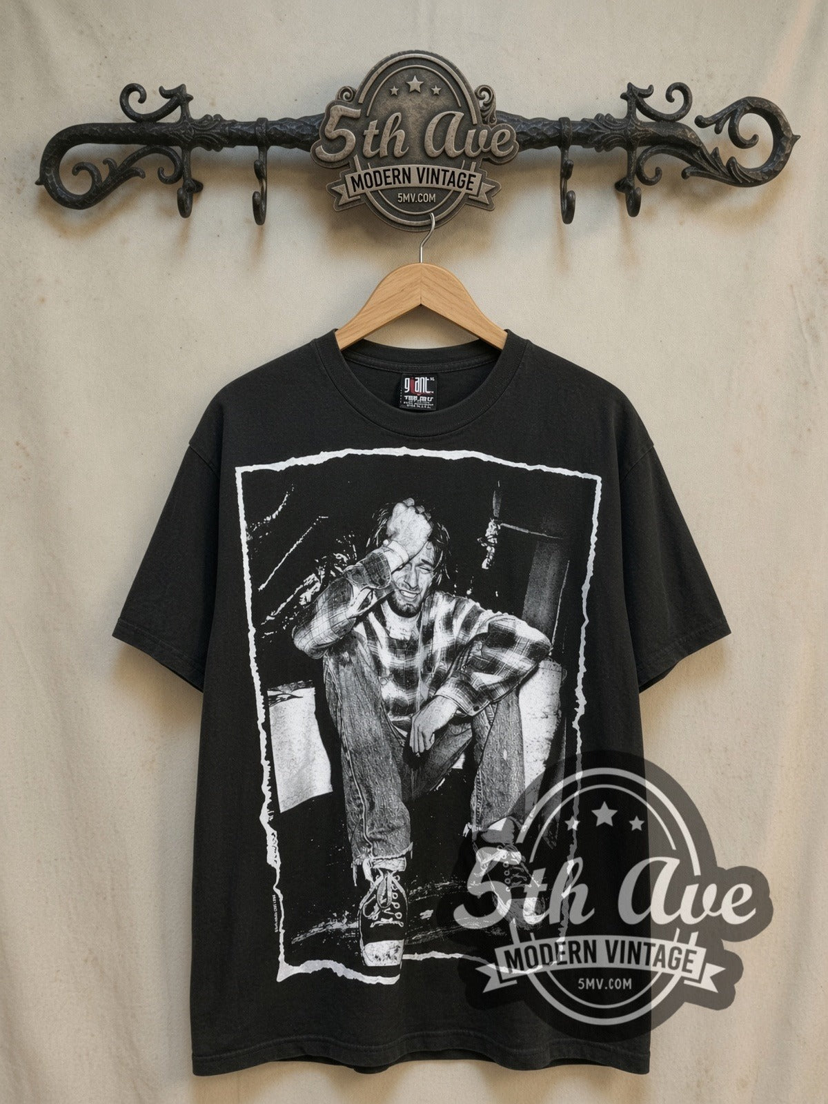 Nirvana Kurt Cobain all-over-print vintage band t-shirt, front view on a display rack