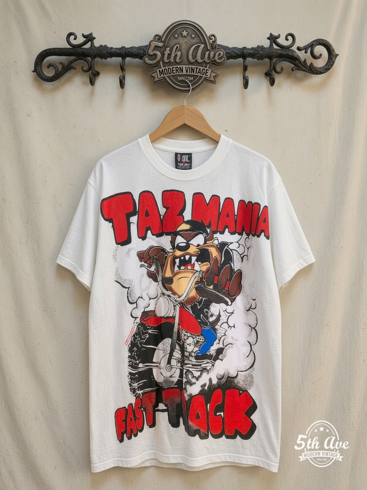 Looney Tunes – Taz-Mania Fast Track – All Over Print – New Vintage Graphic Tee — front on locked cream ornate 5th Ave rack