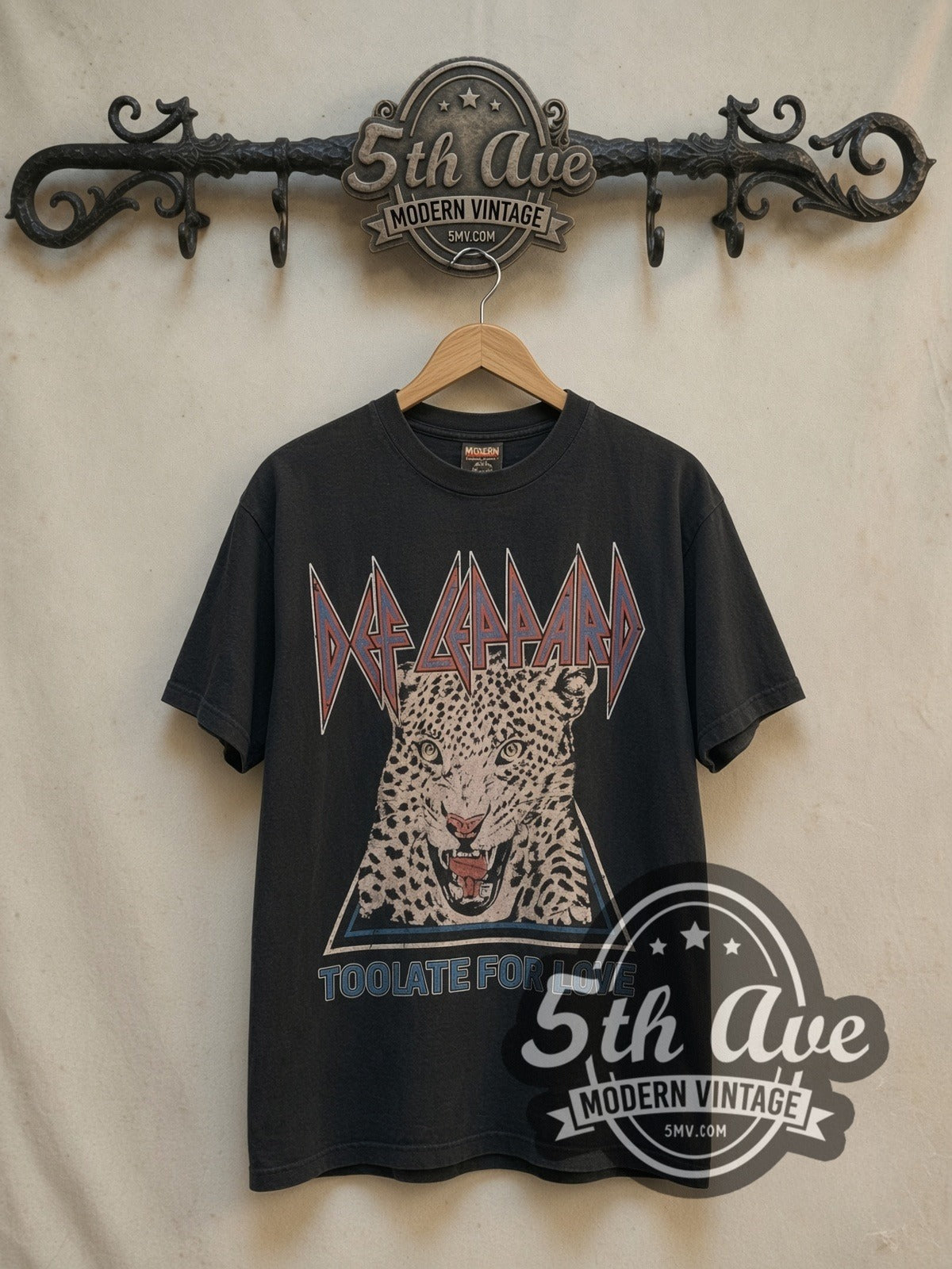 Def Leppard Too Late For Love Leopard Triangle vintage band t-shirt, front view on a display rack