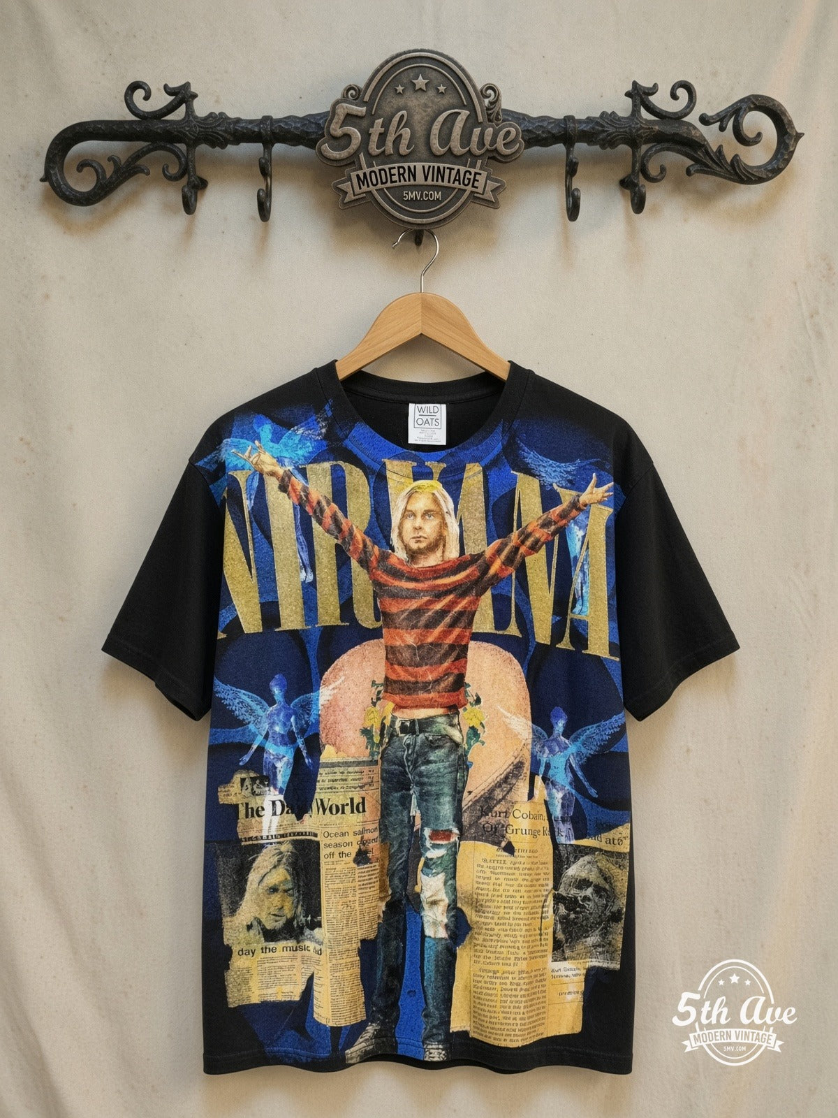 Kurt Cobain – Nirvana in The Daily World – All Over Print – Vintage Band T-Shirt — front on locked cream ornate 5th Ave rack