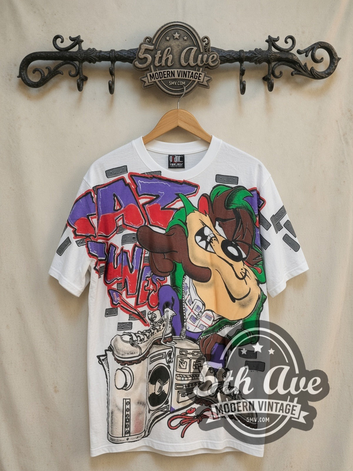 Looney Tunes Taz-Mania Classic Look all-over-print vintage cartoon tee, front view on a display rack