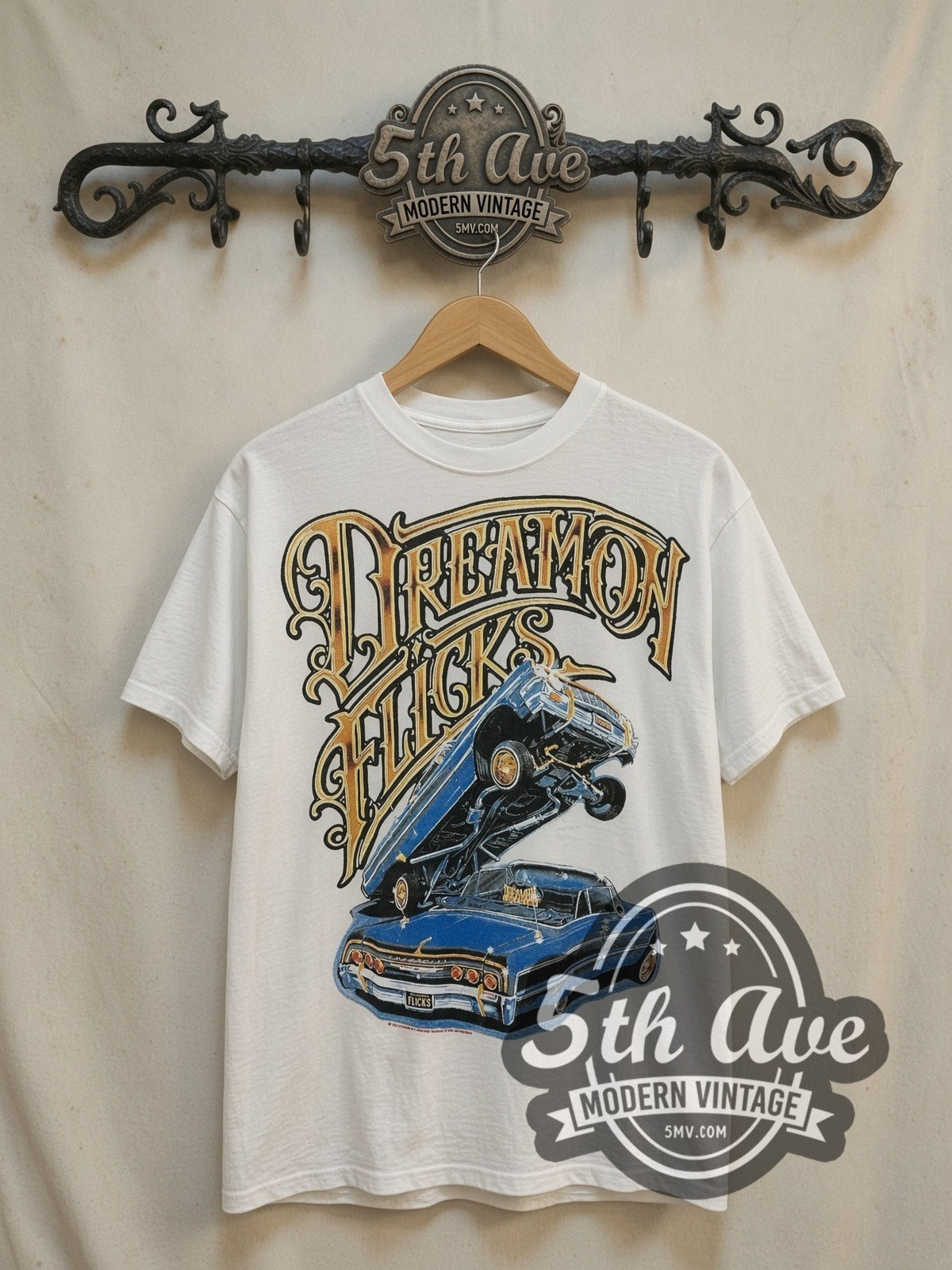 Rollin Hard White-on-White Lowrider Dreams vintage graphic tee in white, front view on a display rack