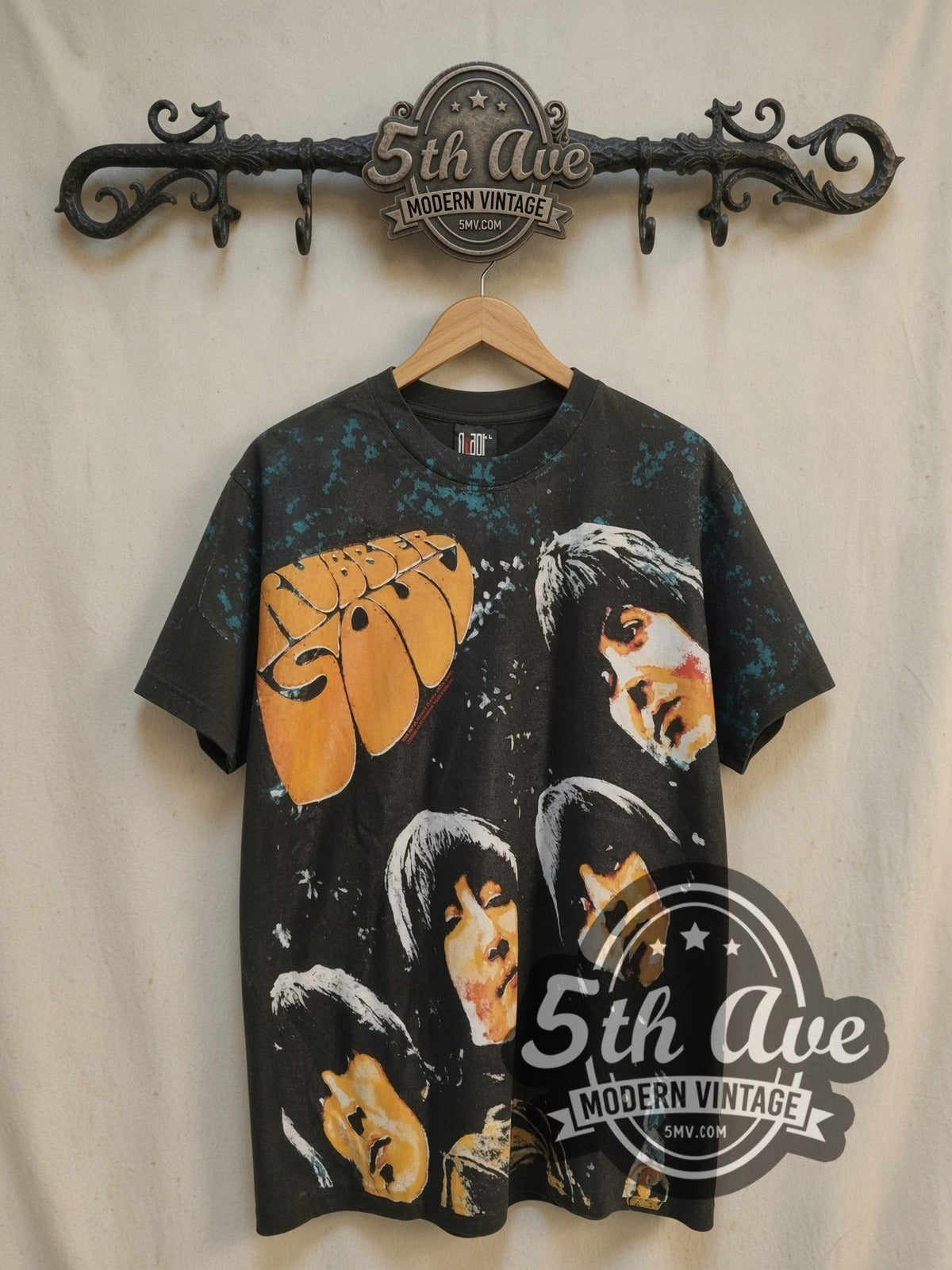 The Beatles Rubber Soul all-over-print vintage band t-shirt, front view on a display rack