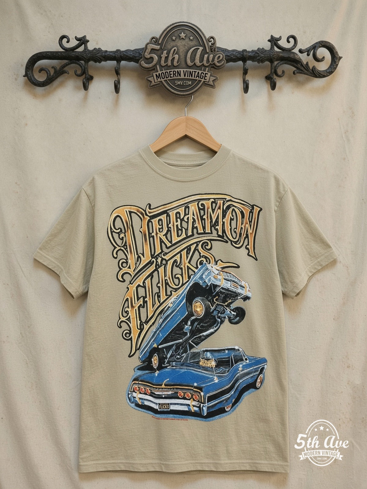 Rollin Hard Dream On Flicks Lowriders graphic tee, front view on a display rack