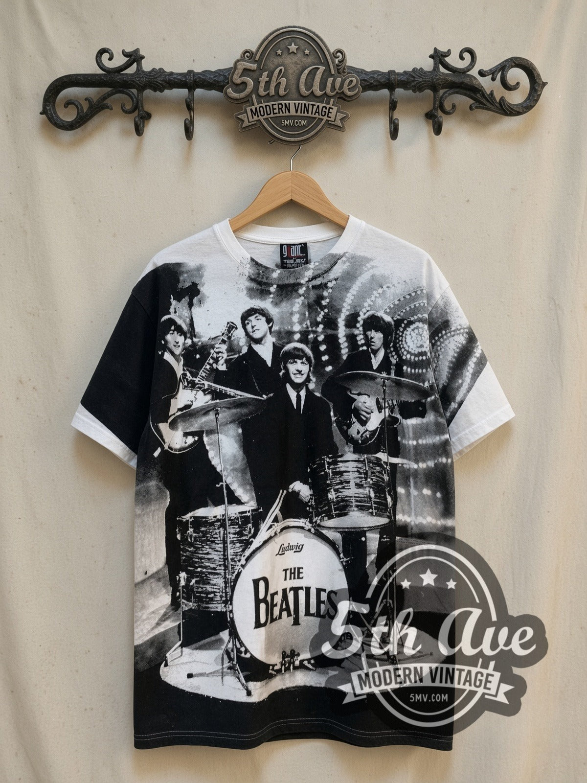 The Beatles Live Stage Ludwig Drum all-over-print vintage band t-shirt in white, front view on a display rack