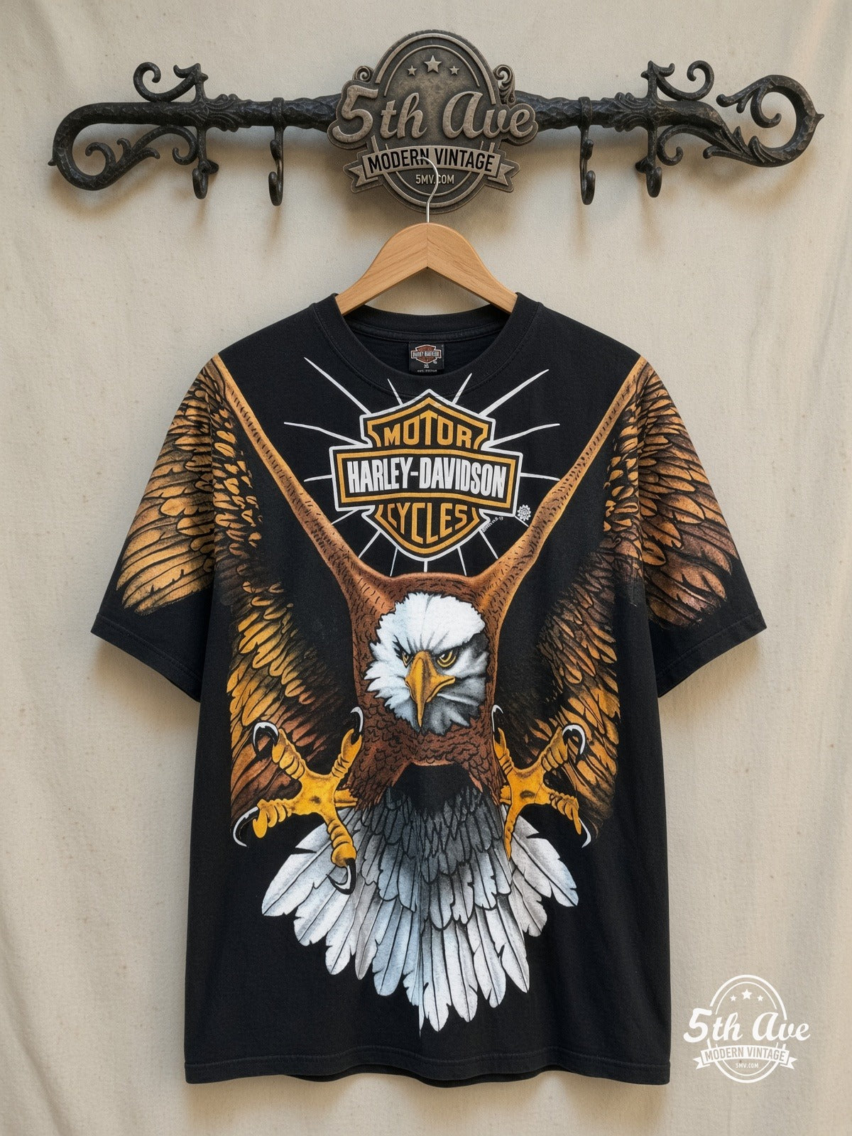 Harley-Davidson all-over-print graphic tee, front view on a display rack